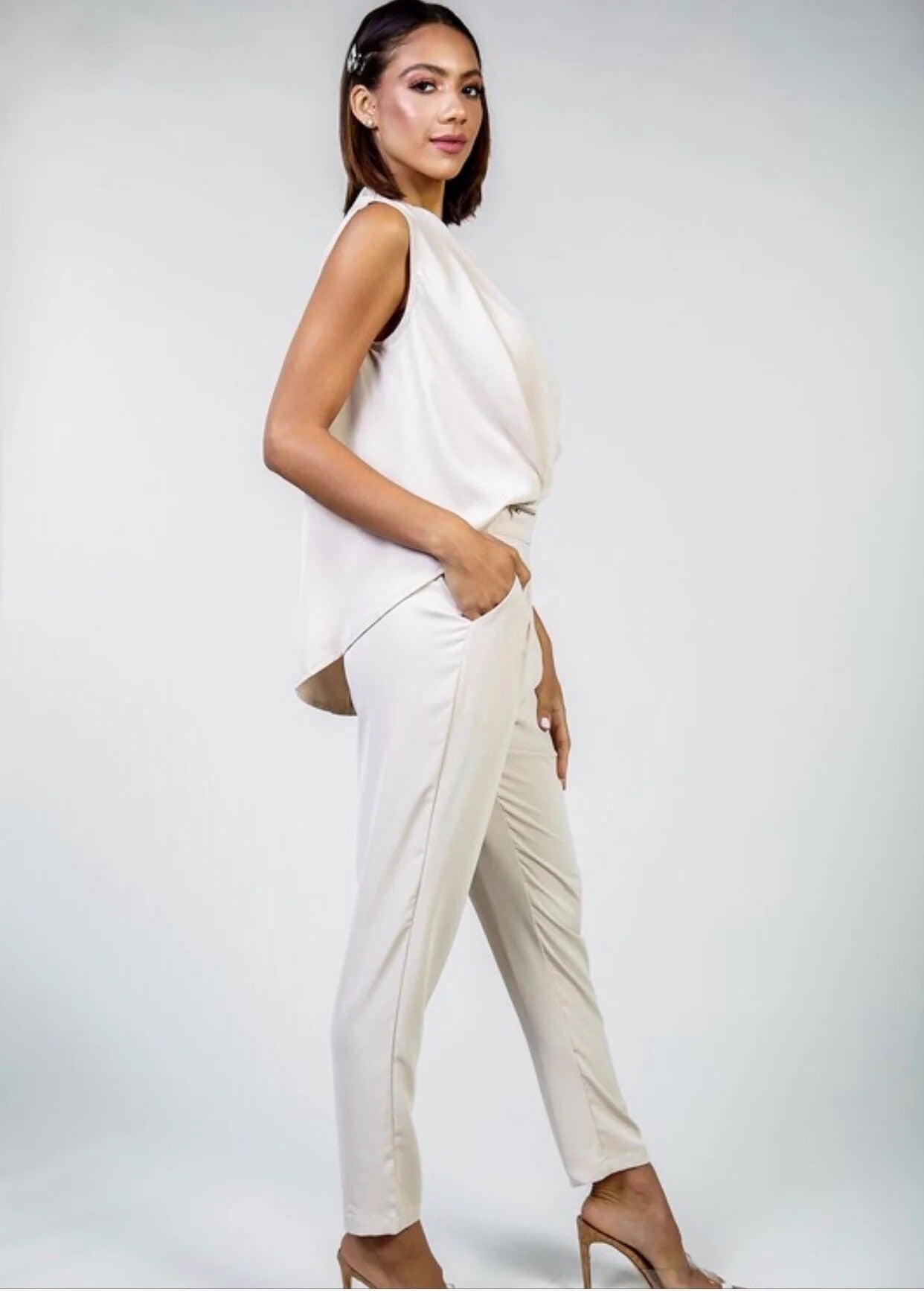 A stylish V-Neck Jumpsuit featuring a flattering mid-section fit, short sleeves, and hand pockets, perfect for parties and events.