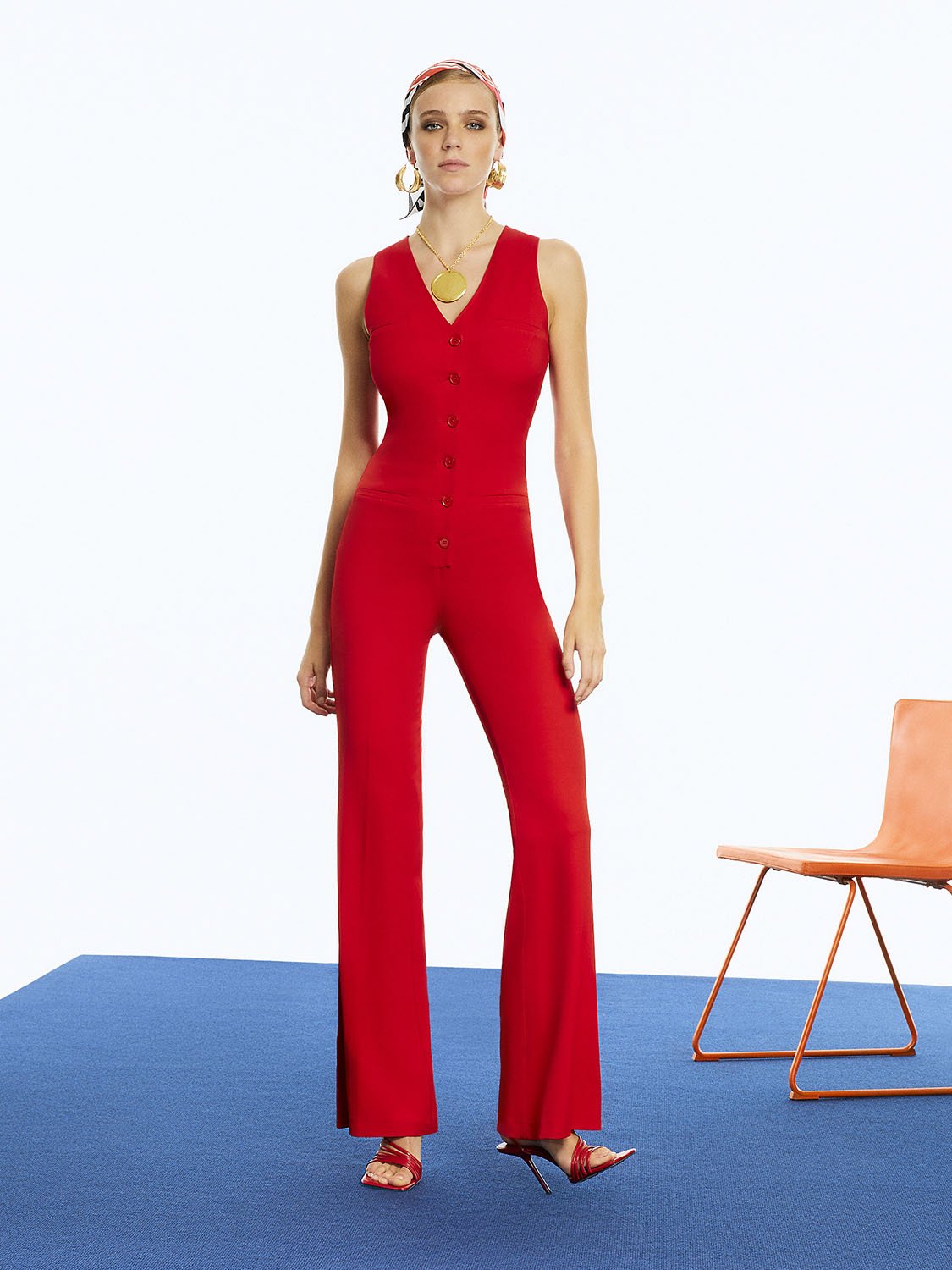 A stylish sleeveless V-Neck Jumpsuit featuring a front button closure, adjustable waistband, and welt pockets, perfect for any occasion.