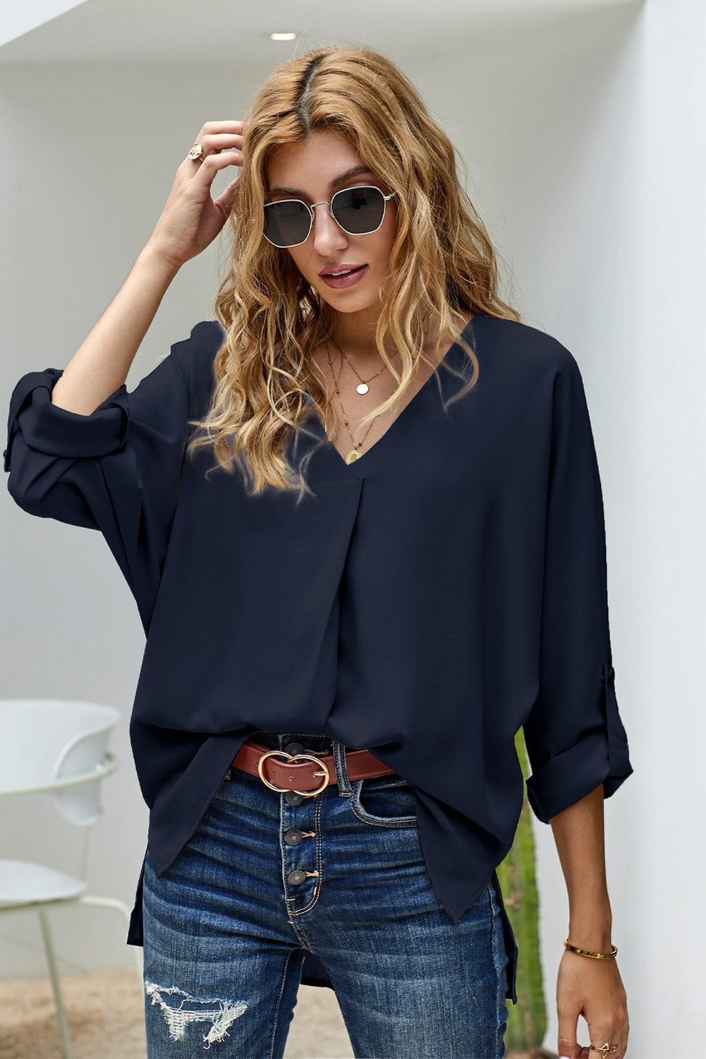 V-Neck Roll-Tab Sleeve Blouse in solid color, featuring three-quarter sleeves and a stylish V-neckline.