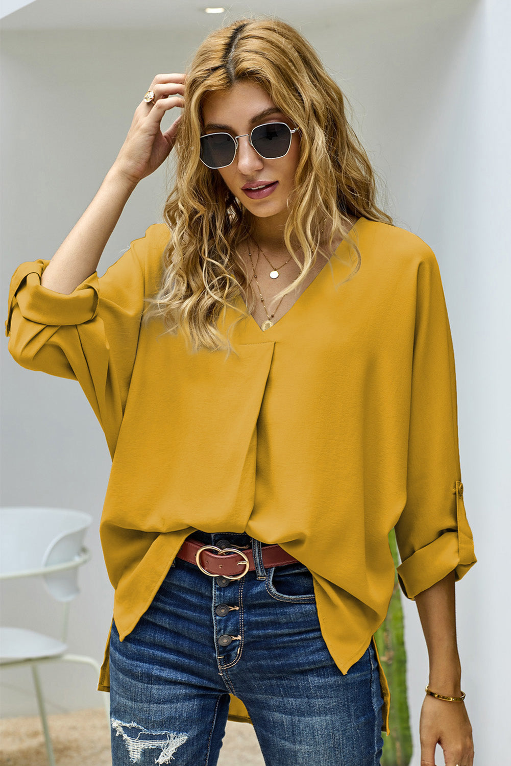 V-Neck Roll-Tab Sleeve Blouse in solid color, featuring three-quarter sleeves and a stylish V-neckline.