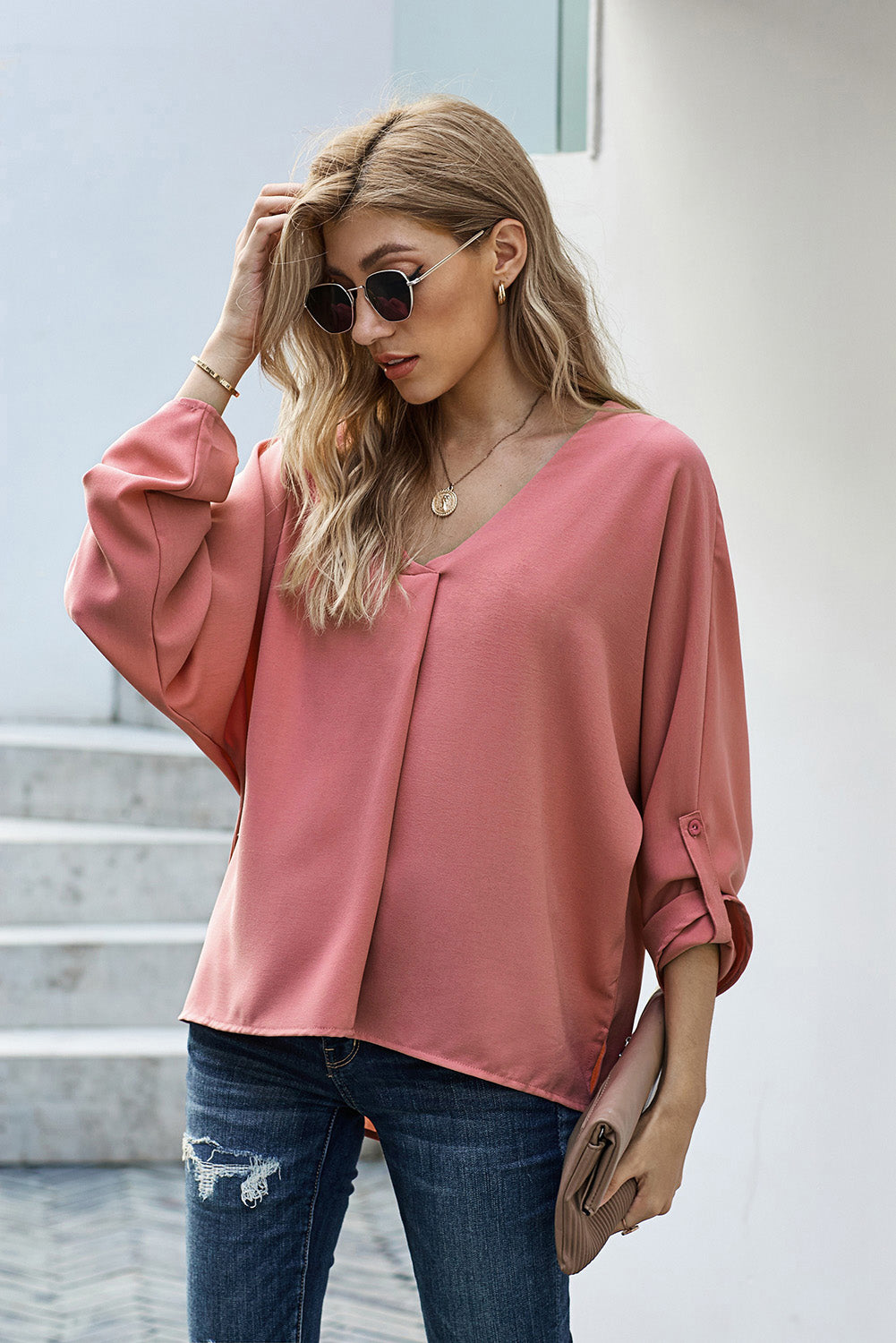 V-Neck Roll-Tab Sleeve Blouse in solid color, featuring three-quarter sleeves and a stylish V-neckline.