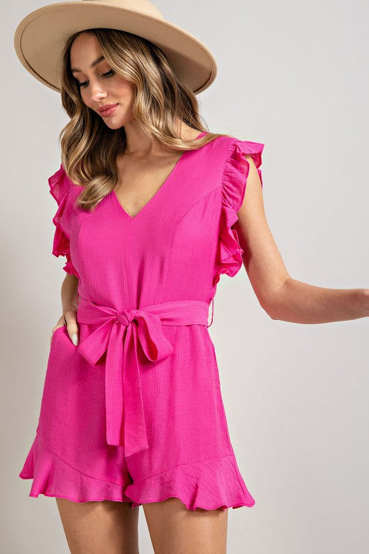 A stylish V-neck ruffled waist tie romper in a chic design, showcasing ruffle trim and a flattering silhouette.