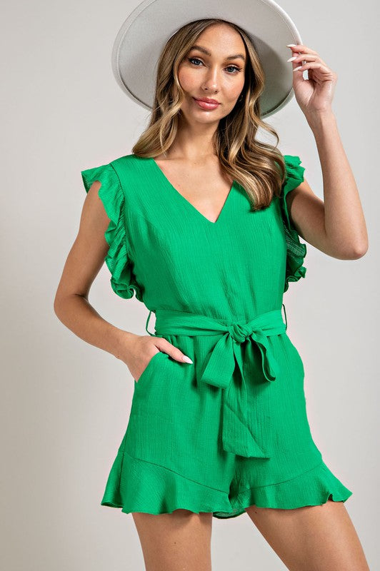 A stylish V-neck ruffled waist tie romper in a chic design, showcasing ruffle trim and a flattering silhouette.