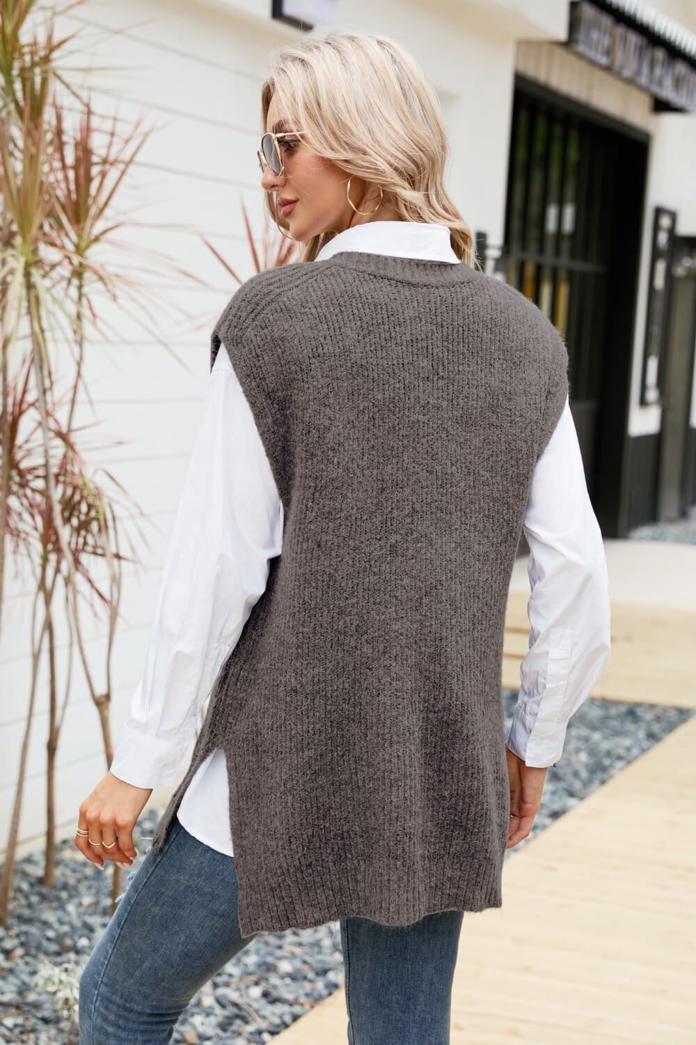 A stylish V-Neck Side Slit Sweater Vest in a solid color, featuring side slits and a long length, perfect for casual outdoor wear.