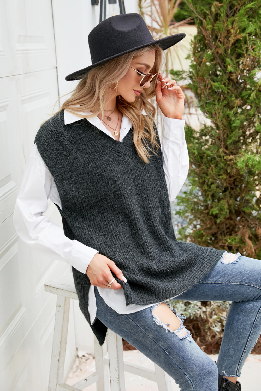 A stylish V-Neck Side Slit Sweater Vest in a solid color, featuring side slits and a long length, perfect for casual outdoor wear.