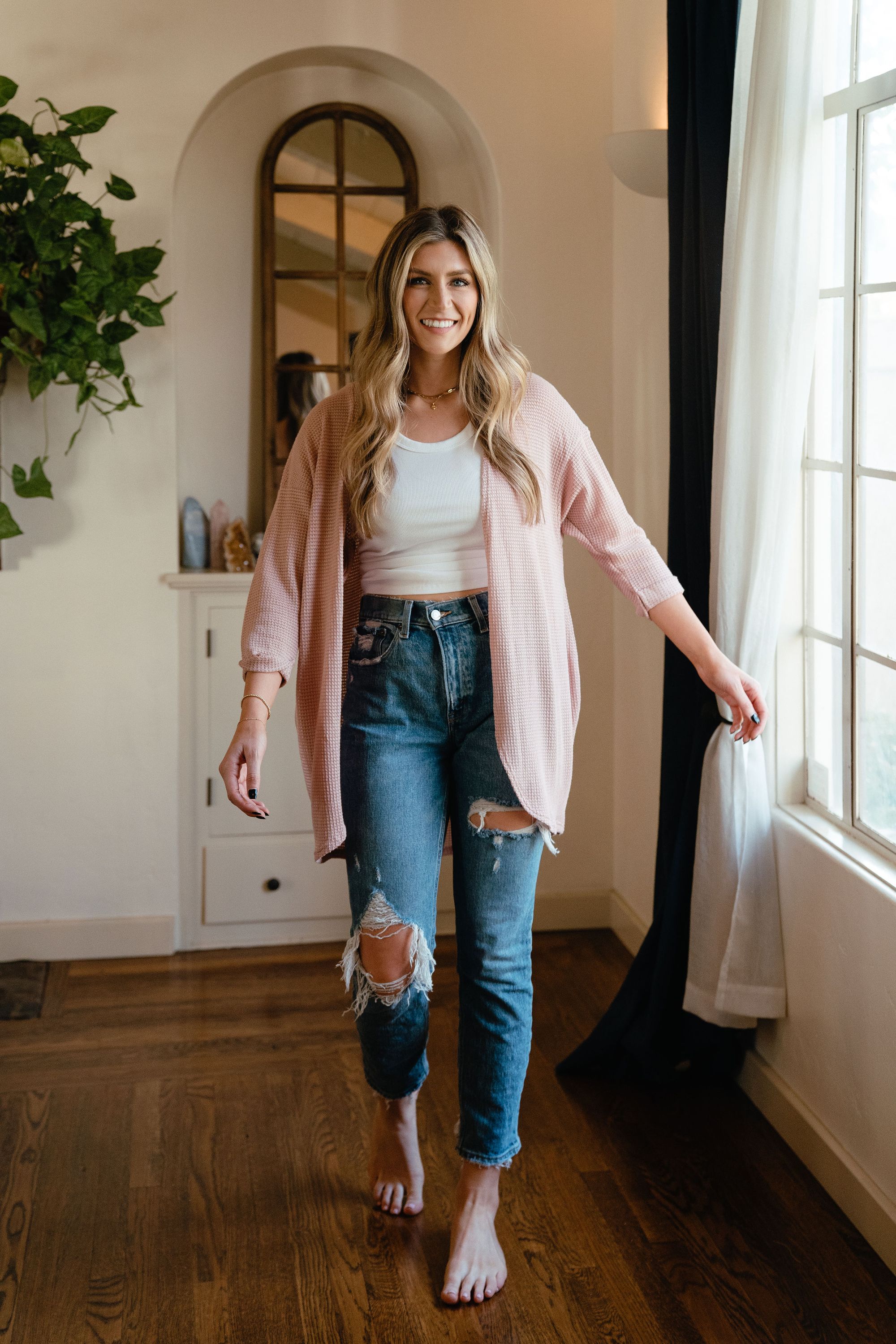 A stylish pink waffle cardigan displayed on a mannequin, showcasing its lightweight texture and versatile design.