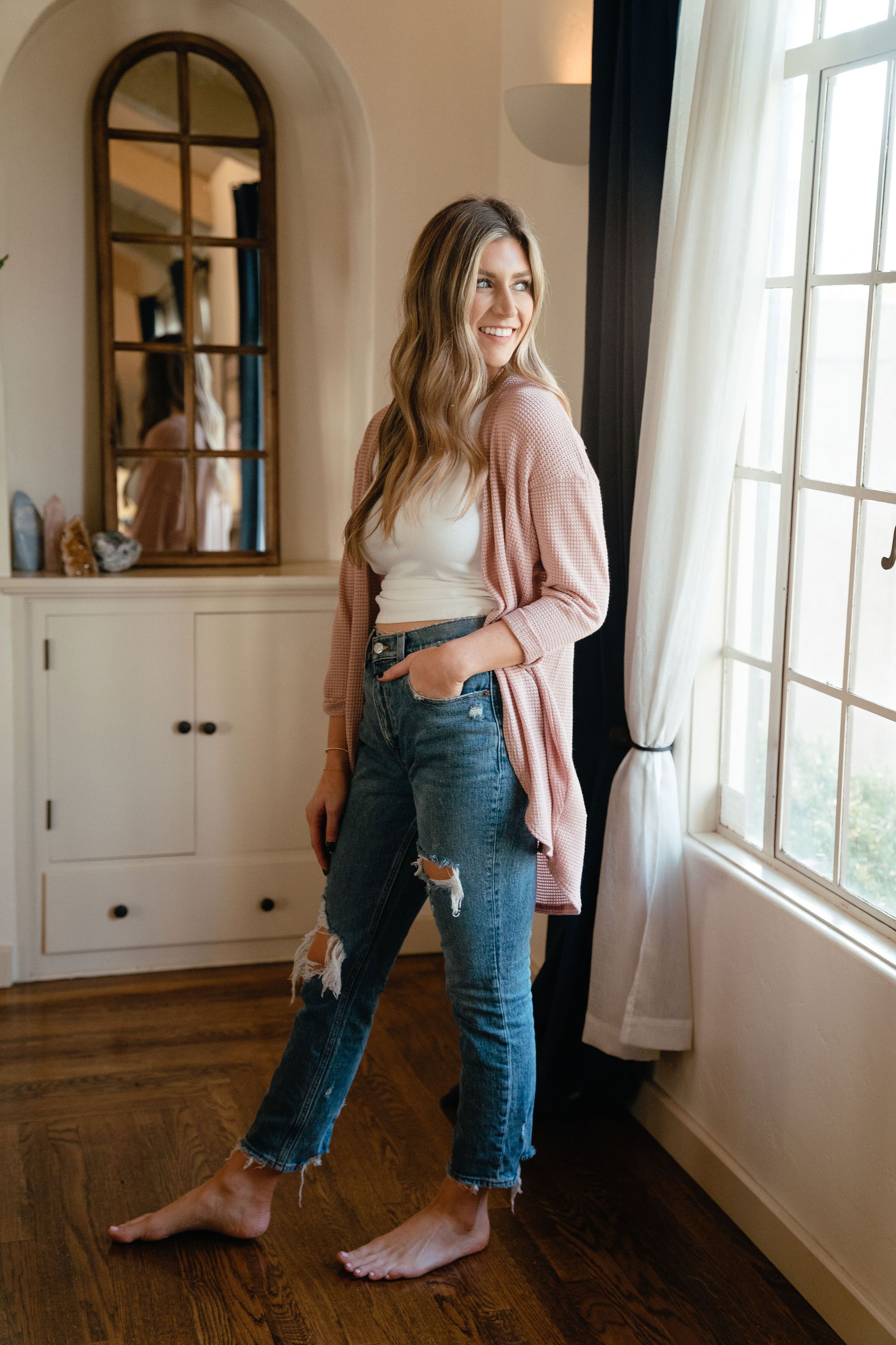 A stylish pink waffle cardigan displayed on a mannequin, showcasing its lightweight texture and versatile design.