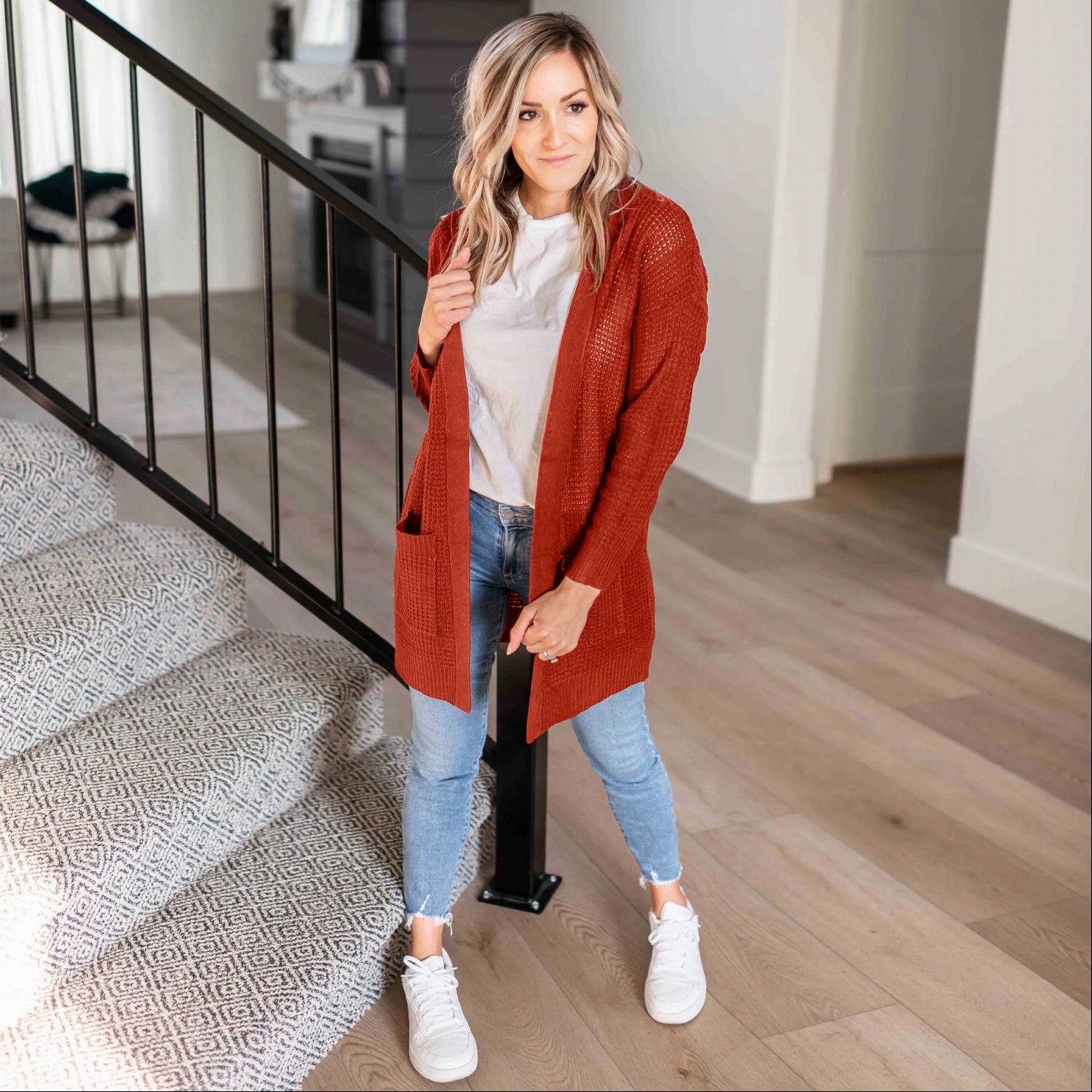 A stylish waffle knit pocketed long sleeve cardigan sweater in a soft fabric, featuring an open front and two large pockets, perfect for fall layering.