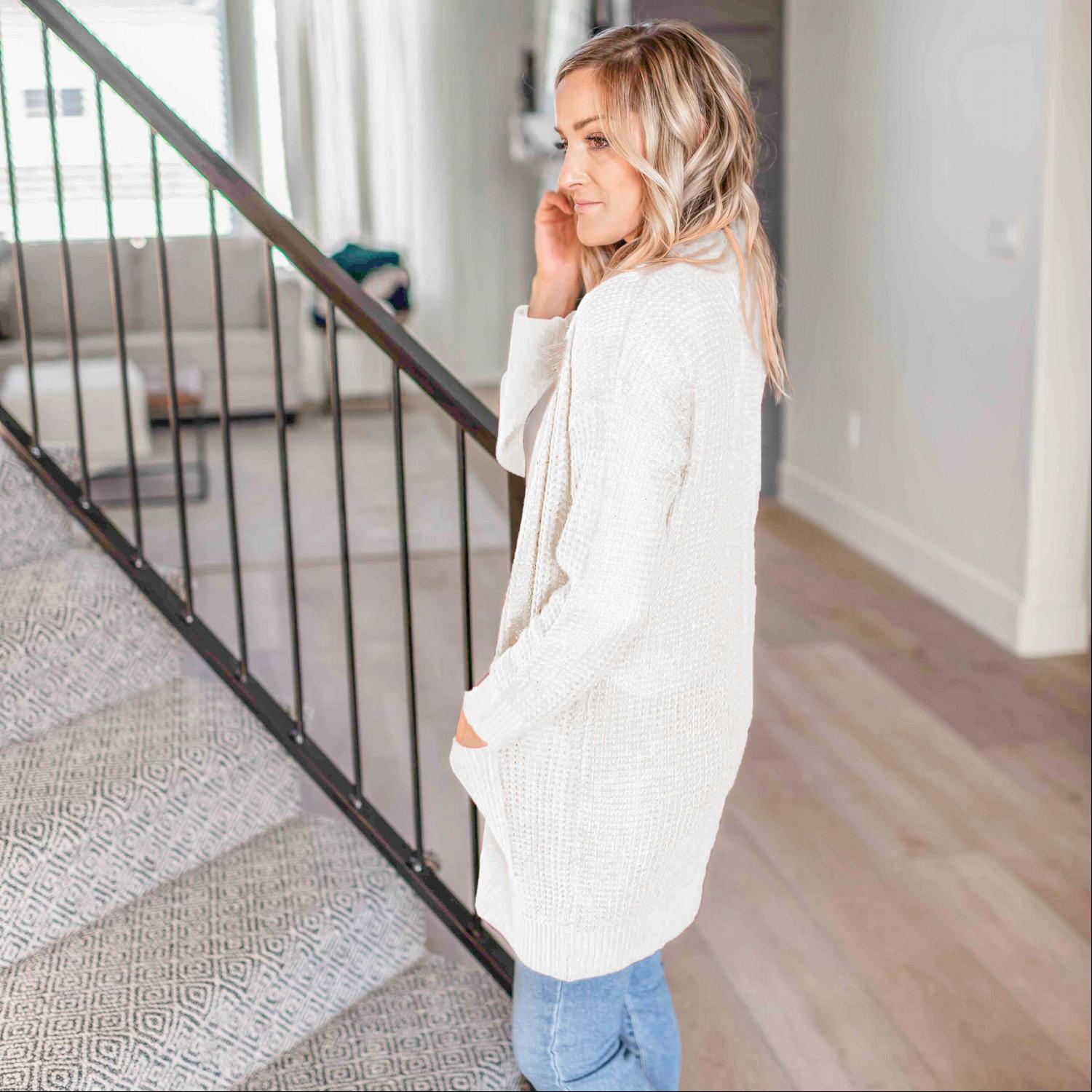 A stylish waffle knit pocketed long sleeve cardigan sweater in a soft fabric, featuring an open front and two large pockets, perfect for fall layering.