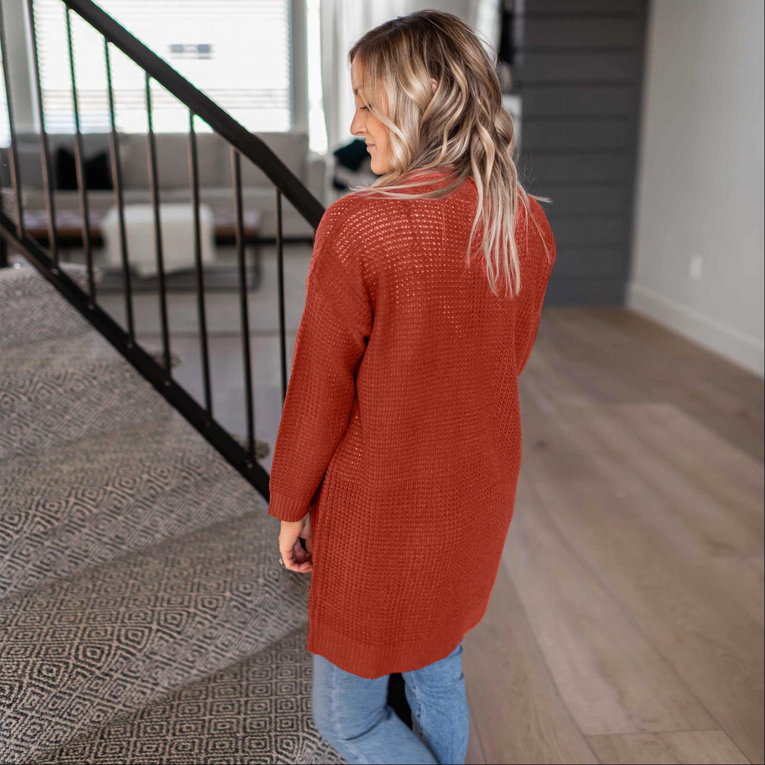 A stylish waffle knit pocketed long sleeve cardigan sweater in a soft fabric, featuring an open front and two large pockets, perfect for fall layering.