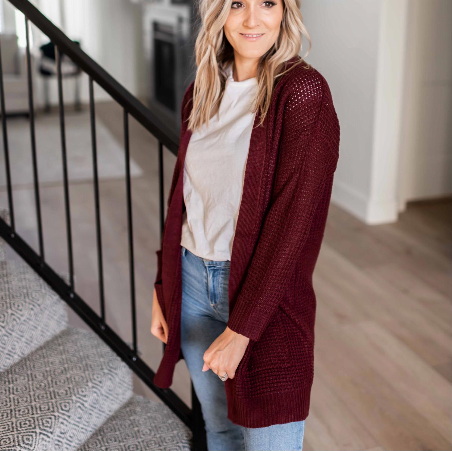 A stylish waffle knit pocketed long sleeve cardigan sweater in a soft fabric, featuring an open front and two large pockets, perfect for fall layering.