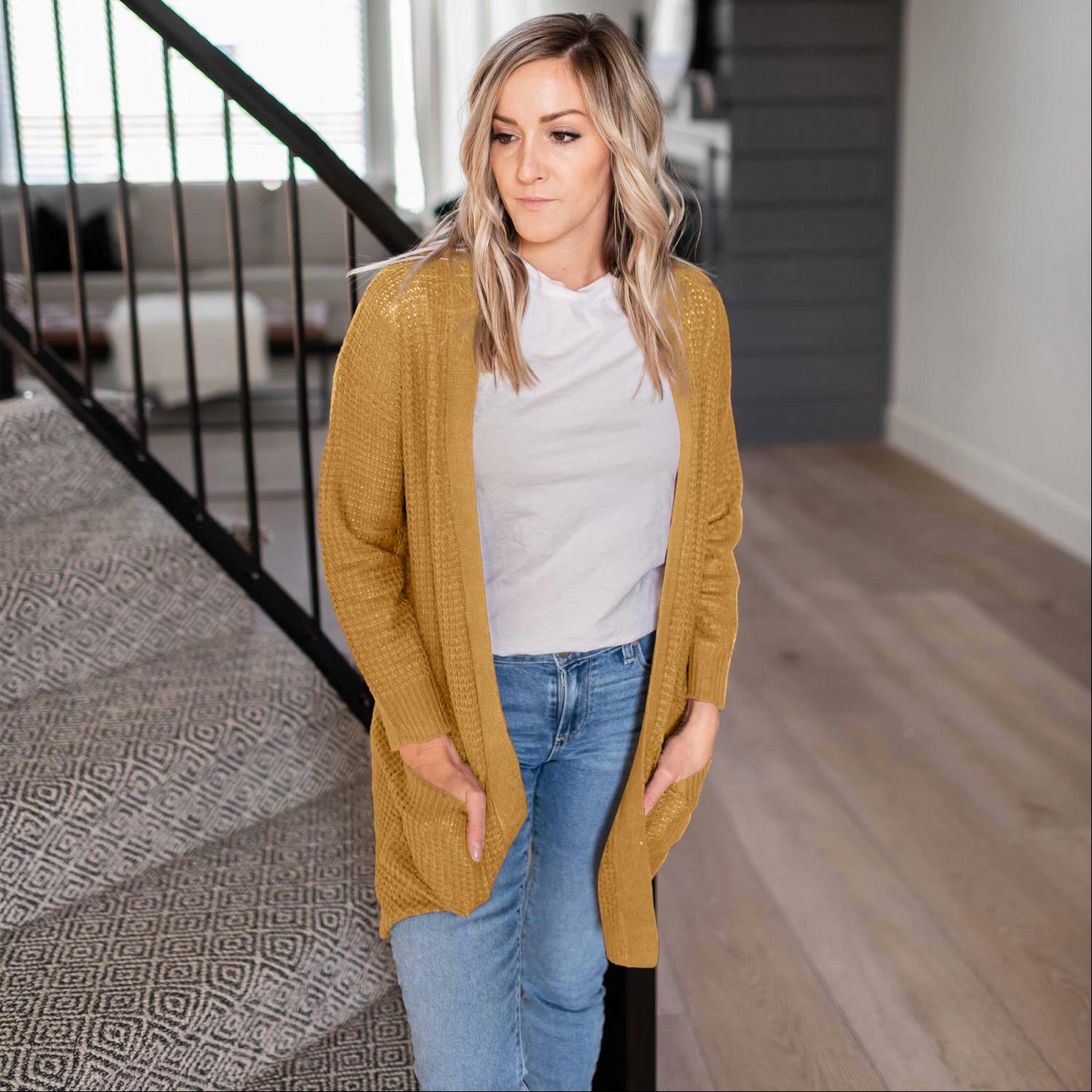 A stylish waffle knit pocketed long sleeve cardigan sweater in a soft fabric, featuring an open front and two large pockets, perfect for fall layering.