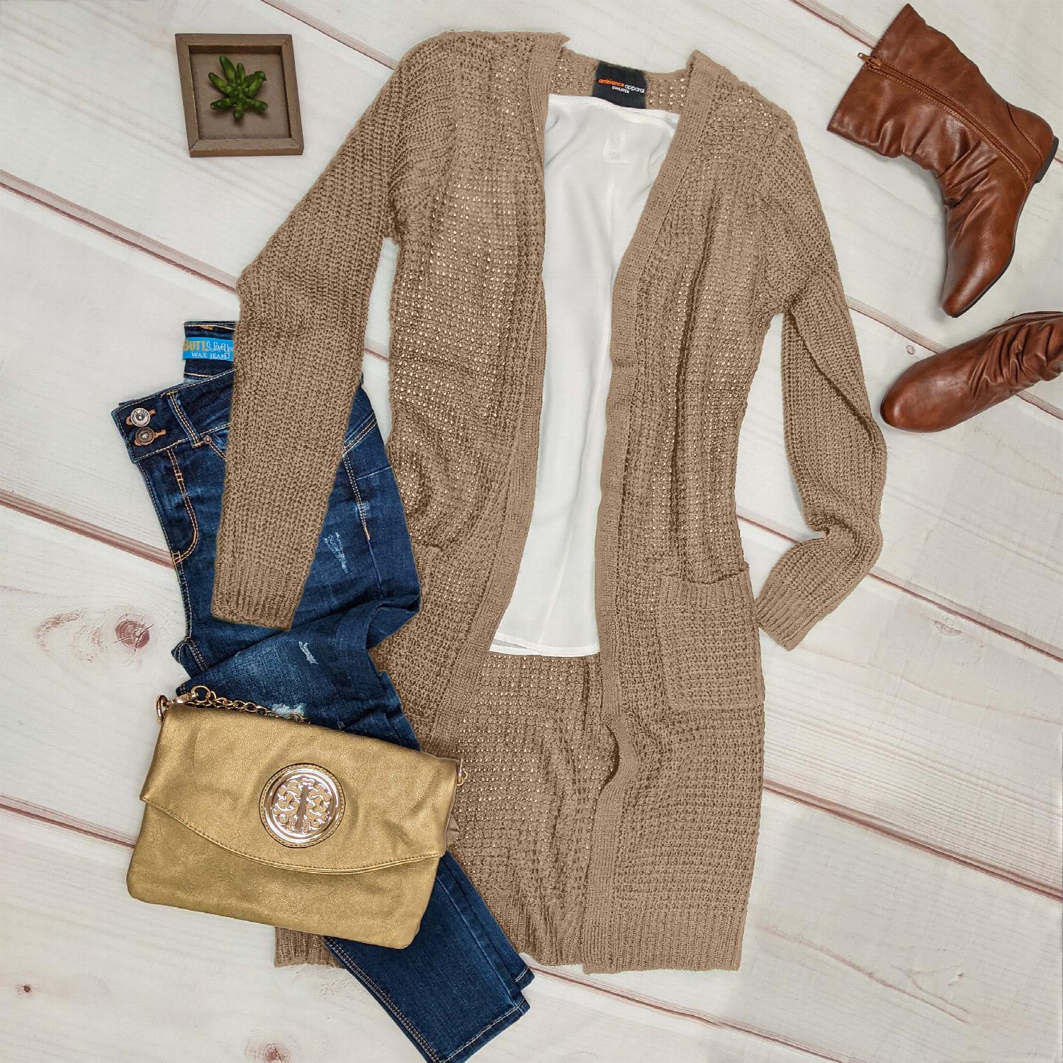 A stylish Waffle Knit Pocketed Low-gauge Open Duster Cardigan in a neutral color, featuring long sleeves and a flowing knee-length design.