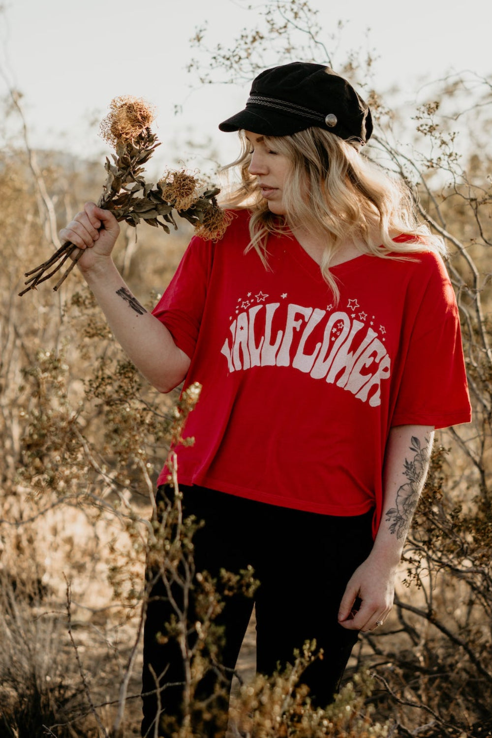 Wallflower Vintage V-Neck T-Shirt in bold red with psychedelic lettering, showcasing a relaxed fit and retro design.