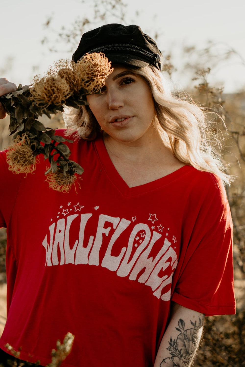 Wallflower Vintage V-Neck T-Shirt in bold red with psychedelic lettering, showcasing a relaxed fit and retro design.