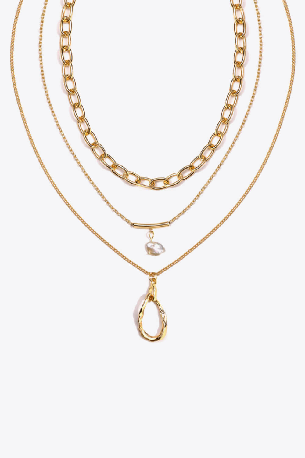 A stylish triple-layered necklace featuring stainless steel, 18k gold plating, and a freshwater pearl, displayed in a studio setting.