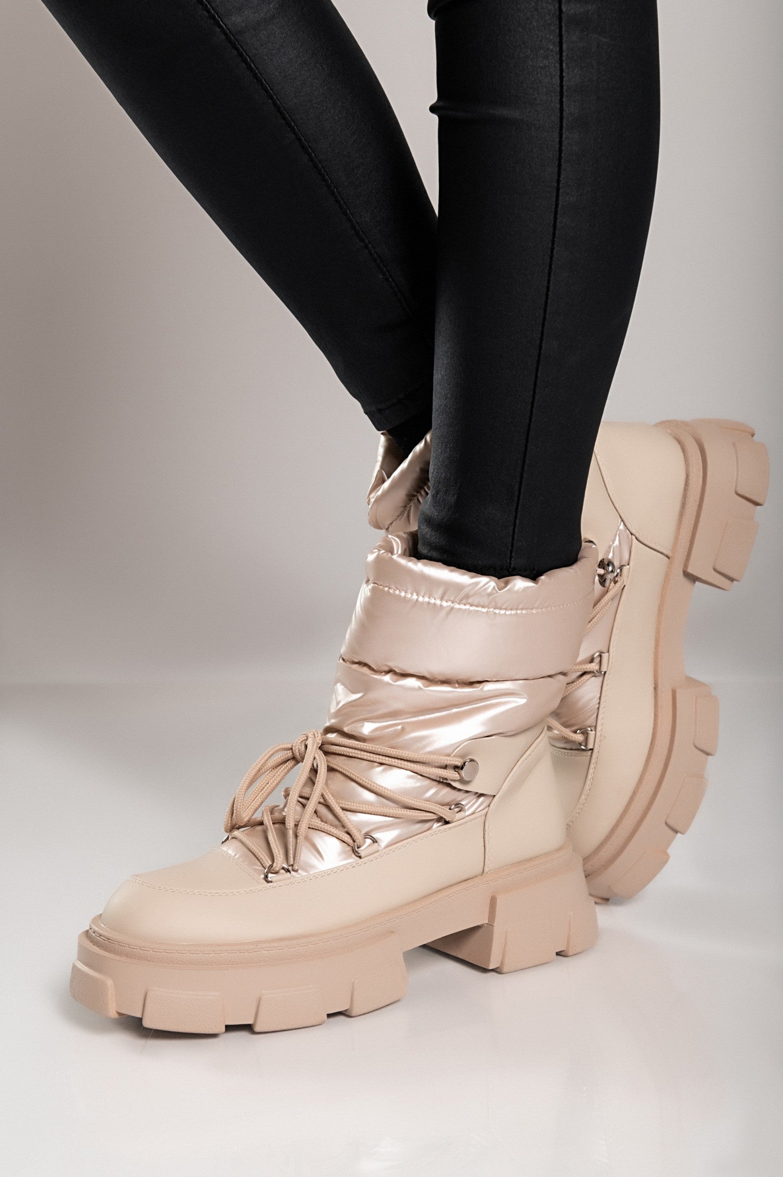 Beige warm ankle boots with bows, featuring a round toe and raised sole, perfect for stylish comfort.