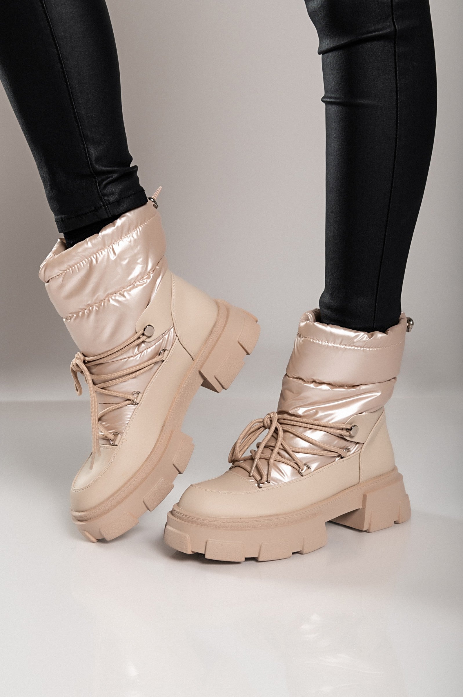 Beige warm ankle boots with bows, featuring a round toe and raised sole, perfect for stylish comfort.