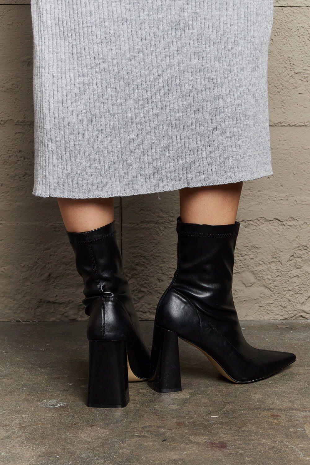 Weeboo Stacy Block Heel Sock Boots featuring a chic pointed toe and shiny block heel, designed for comfort and style.