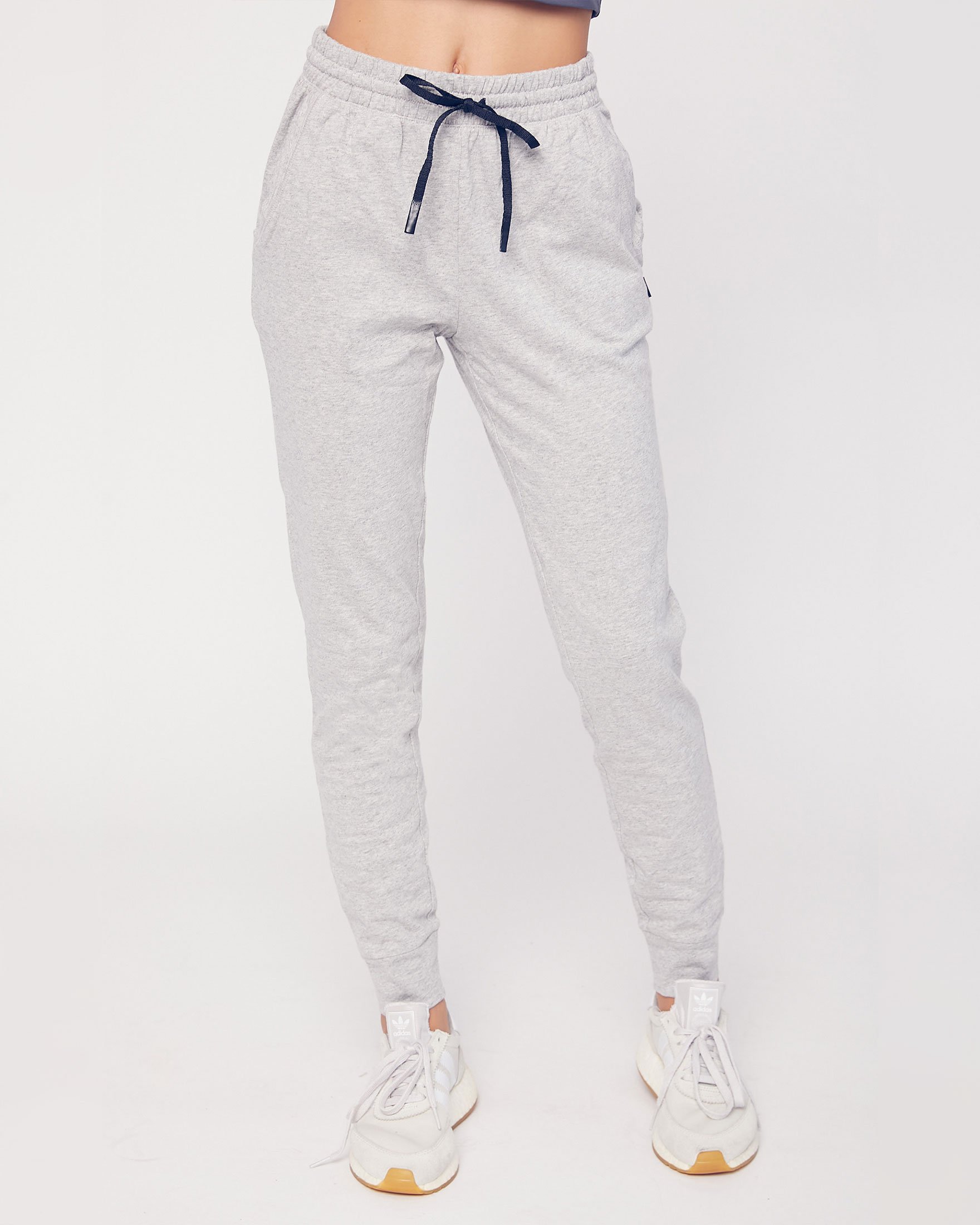 A pair of lightweight joggers designed for comfort and versatility, featuring pockets and drawcords, suitable for lounging and outdoor activities.