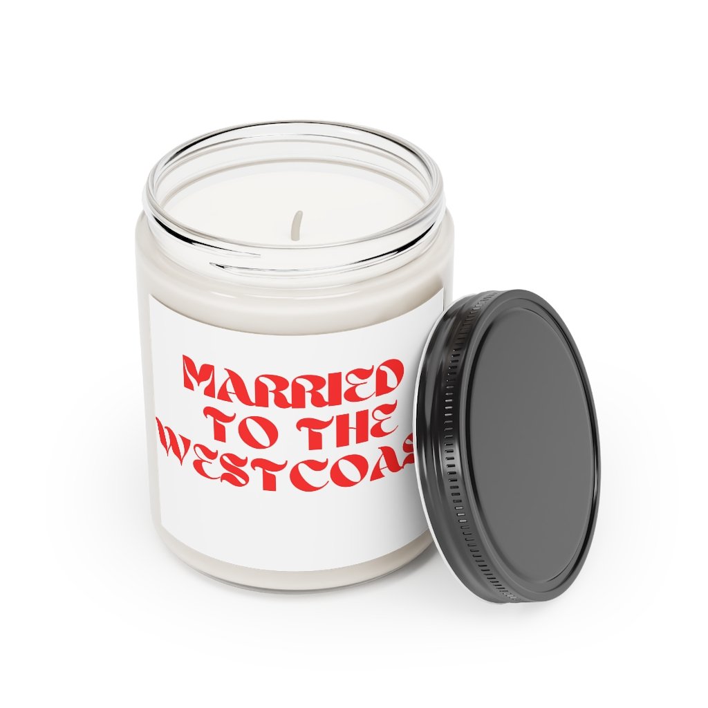 West Coast Love Affair scented candle in a glass container, featuring a warm glow and elegant label, available in Cinnamon Stick and Vanilla scents.