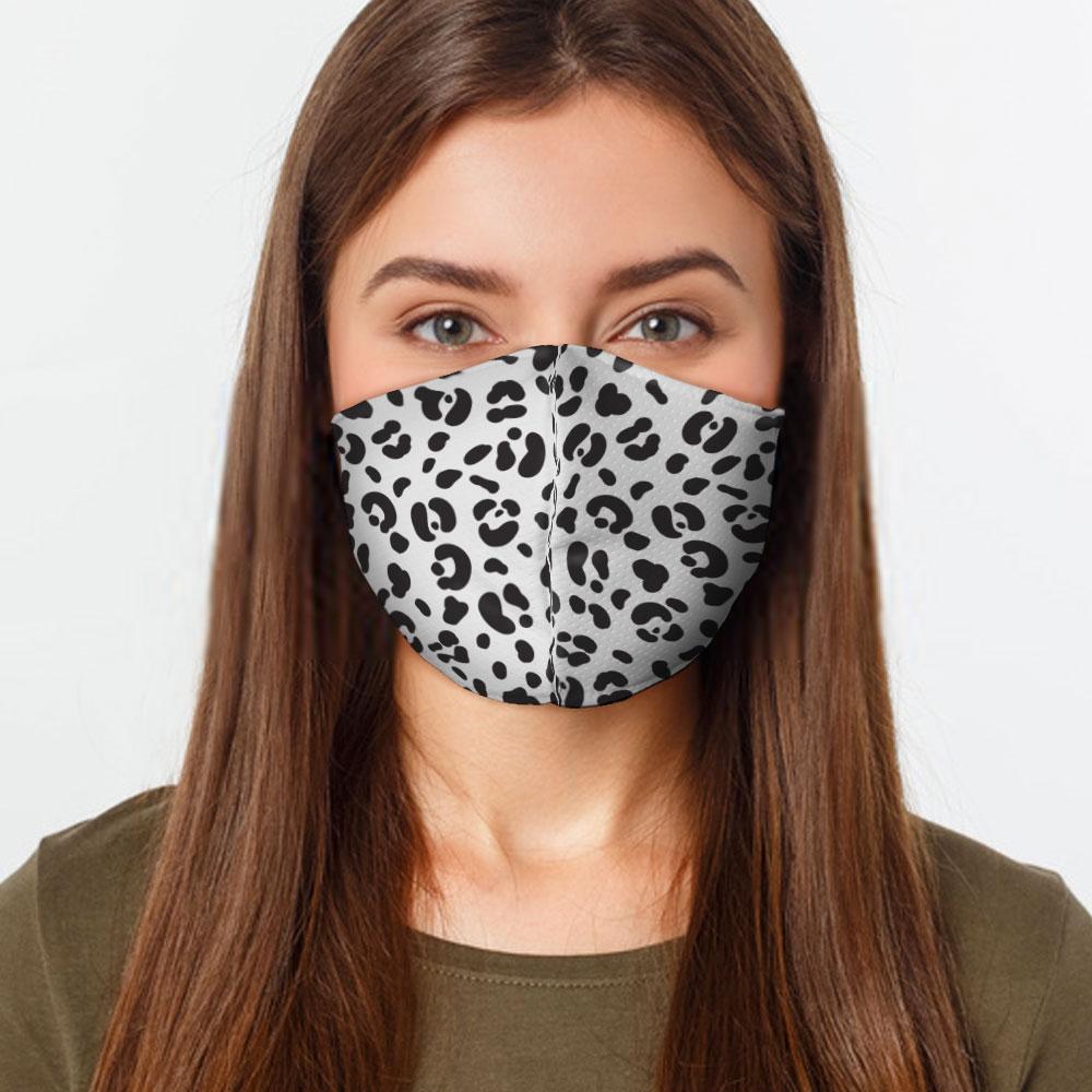 White Cheetah Face Cover with elastic ear bands, showcasing a stylish design and two layers of fabric for filtration.