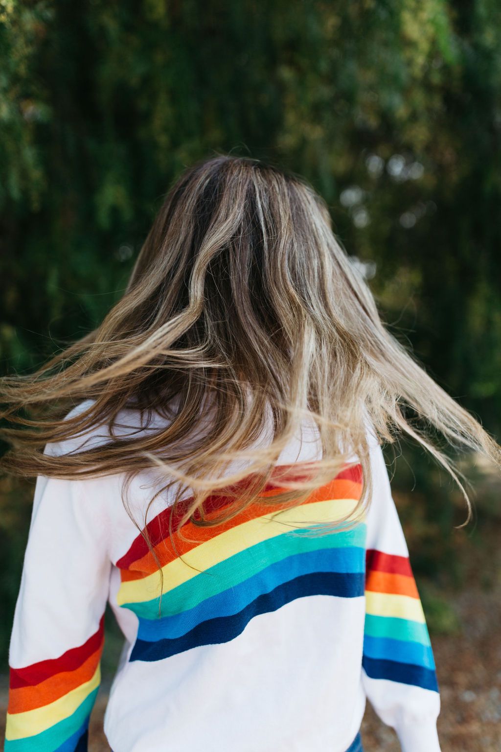 A cozy White Rainbow Sweater featuring a soft fabric blend, perfect for winter layering and stylish outfits.