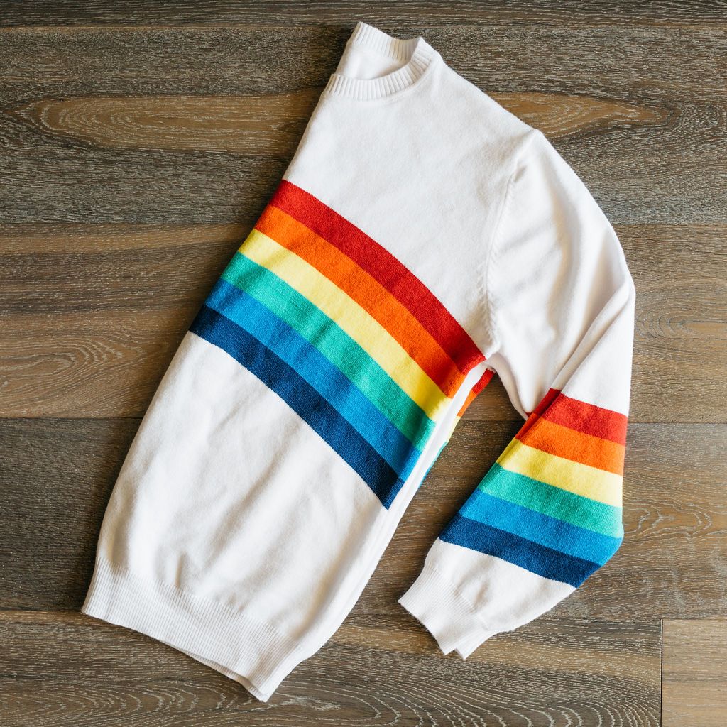 A cozy White Rainbow Sweater featuring a soft fabric blend, perfect for winter layering and stylish outfits.