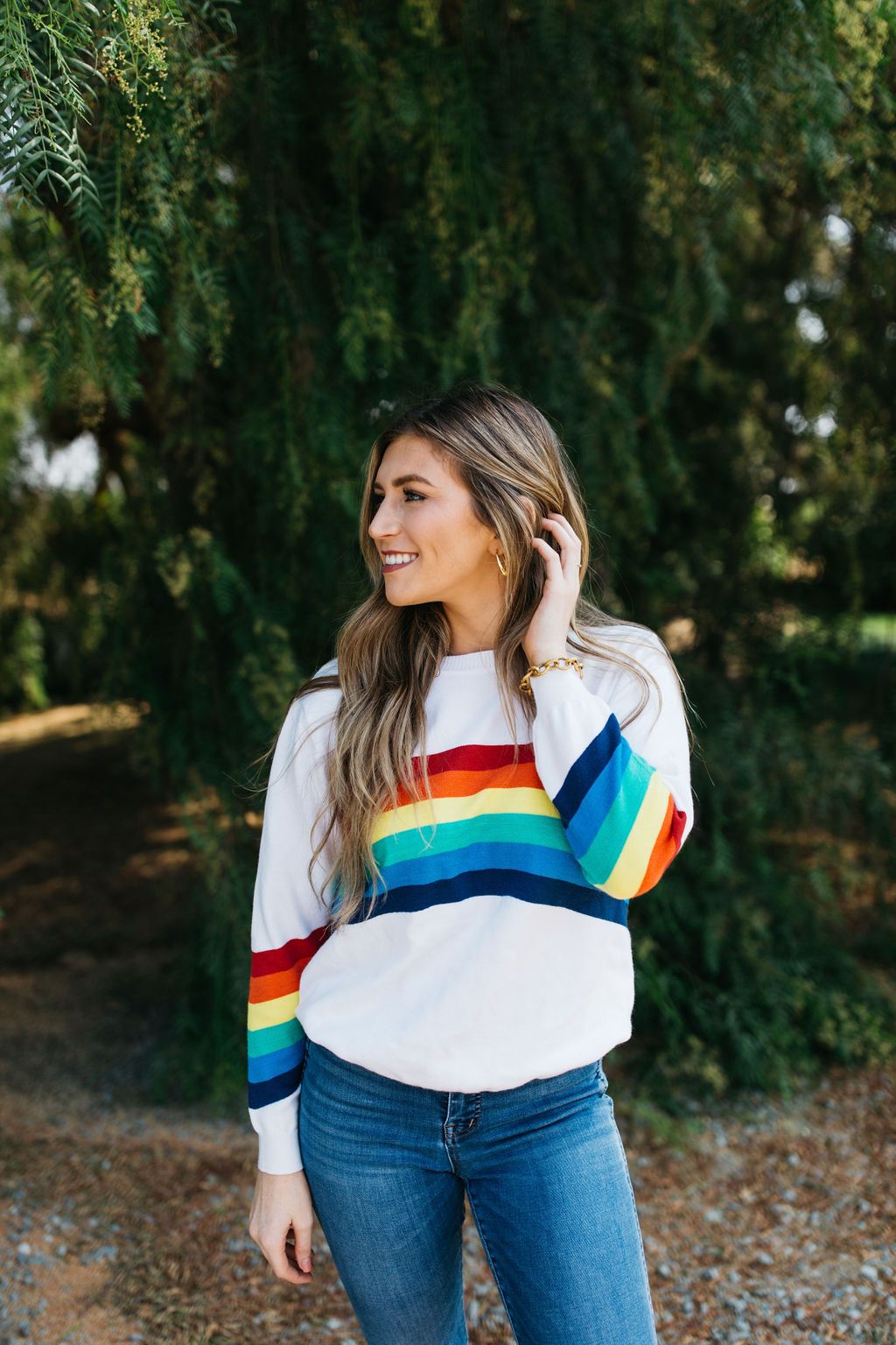 A cozy White Rainbow Sweater featuring a soft fabric blend, perfect for winter layering and stylish outfits.