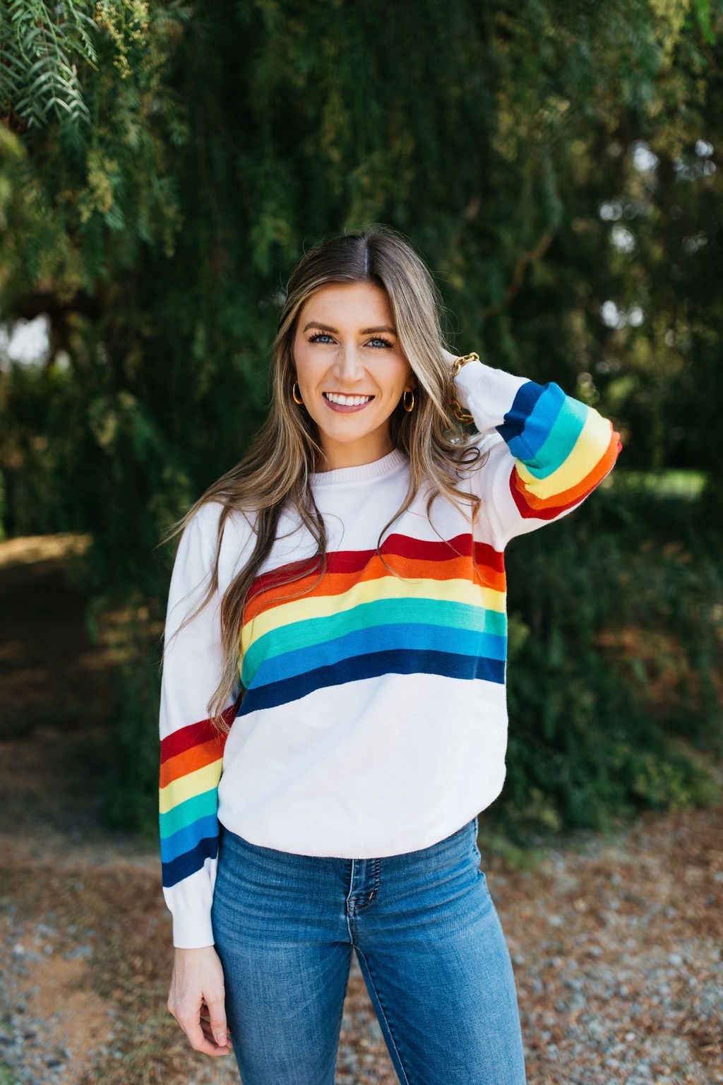 A cozy White Rainbow Sweater featuring a soft fabric blend, perfect for winter layering and stylish outfits.