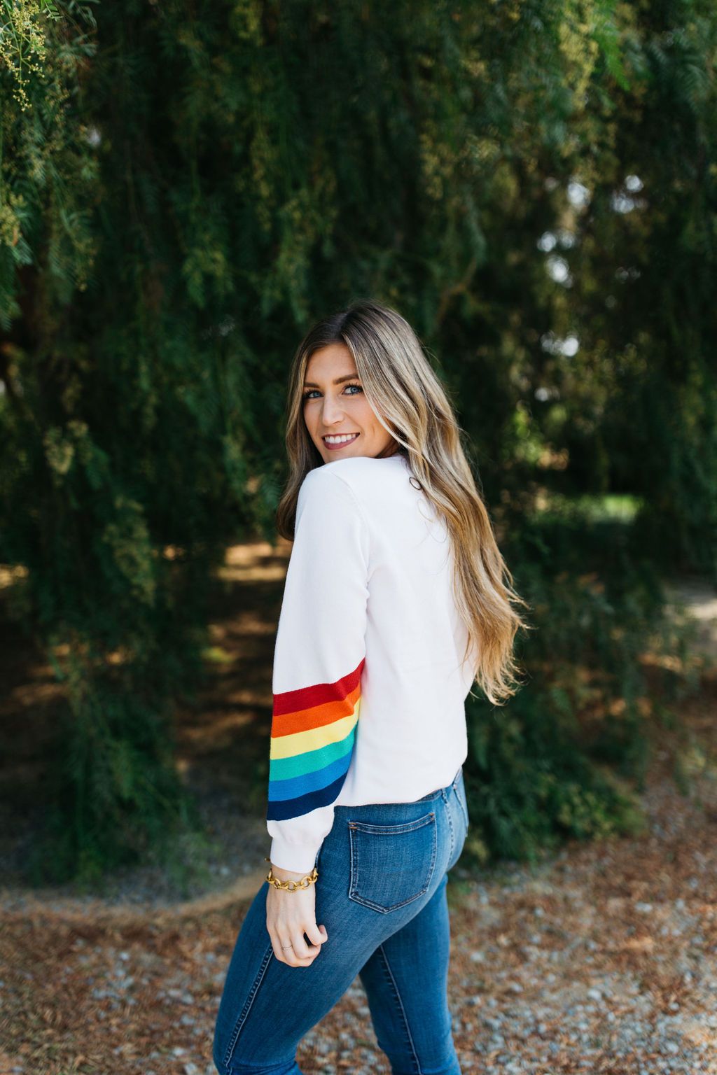 A cozy White Rainbow Sweater featuring a soft fabric blend, perfect for winter layering and stylish outfits.