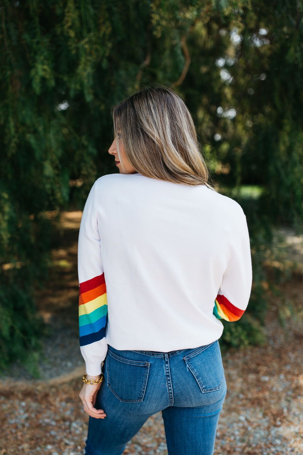 A cozy White Rainbow Sweater featuring a soft fabric blend, perfect for winter layering and stylish outfits.