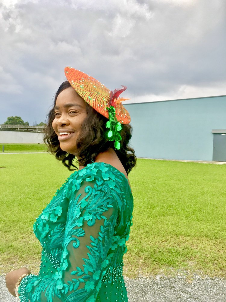 A stylish wide brim hat made from vibrant Ankara fabric, featuring elegant embellishments and Swarovski crystals, perfect for any occasion.