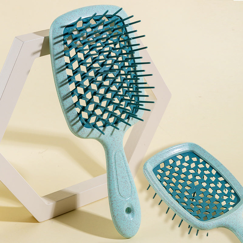 Wide Detangling Brush designed for textured and curly hair, featuring wide bristles for gentle detangling.