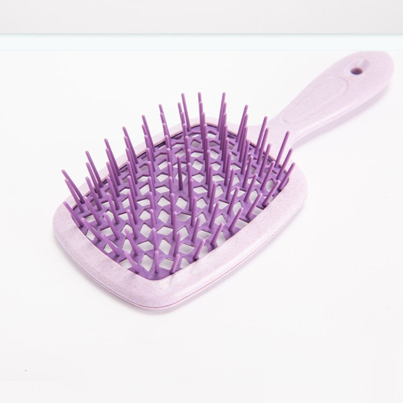 Wide Detangling Brush designed for textured and curly hair, featuring wide bristles for gentle detangling.