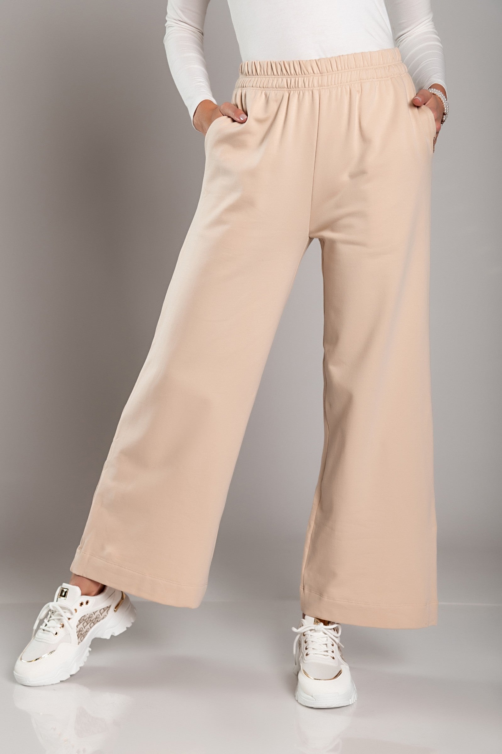 Wide leg cotton sports trousers in black, featuring an elastic waist and side pockets, designed for comfort and style.