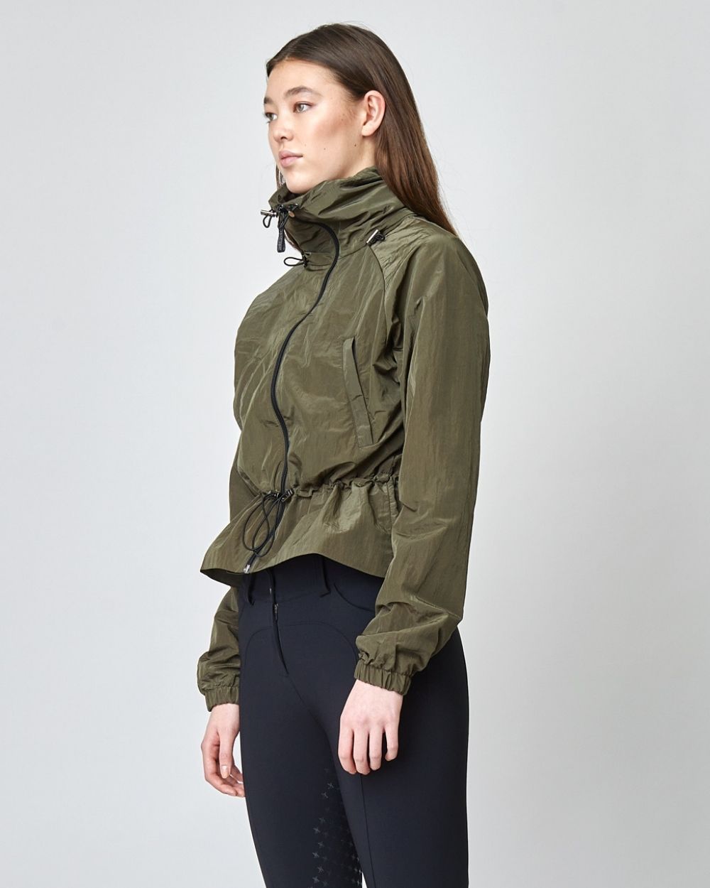 Windproof Riding Jacket in Green, featuring a sleek design, zippered pockets, and a retractable hood, perfect for outdoor riding.