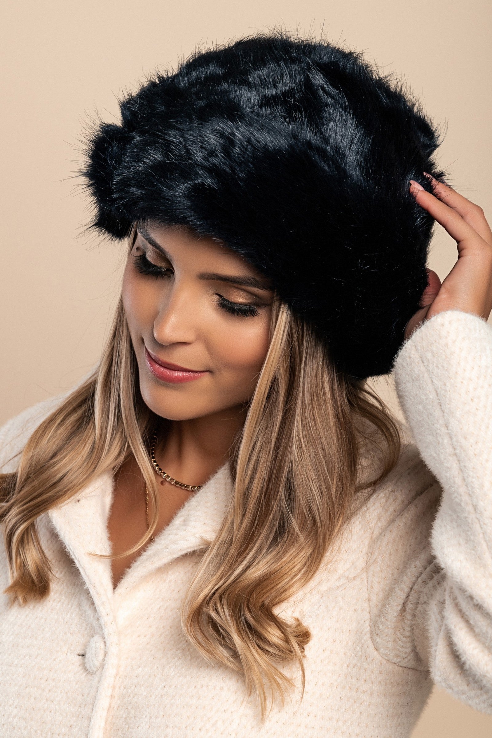 Elegant dark blue winter hat with soft synthetic fur lining, perfect for cold weather.