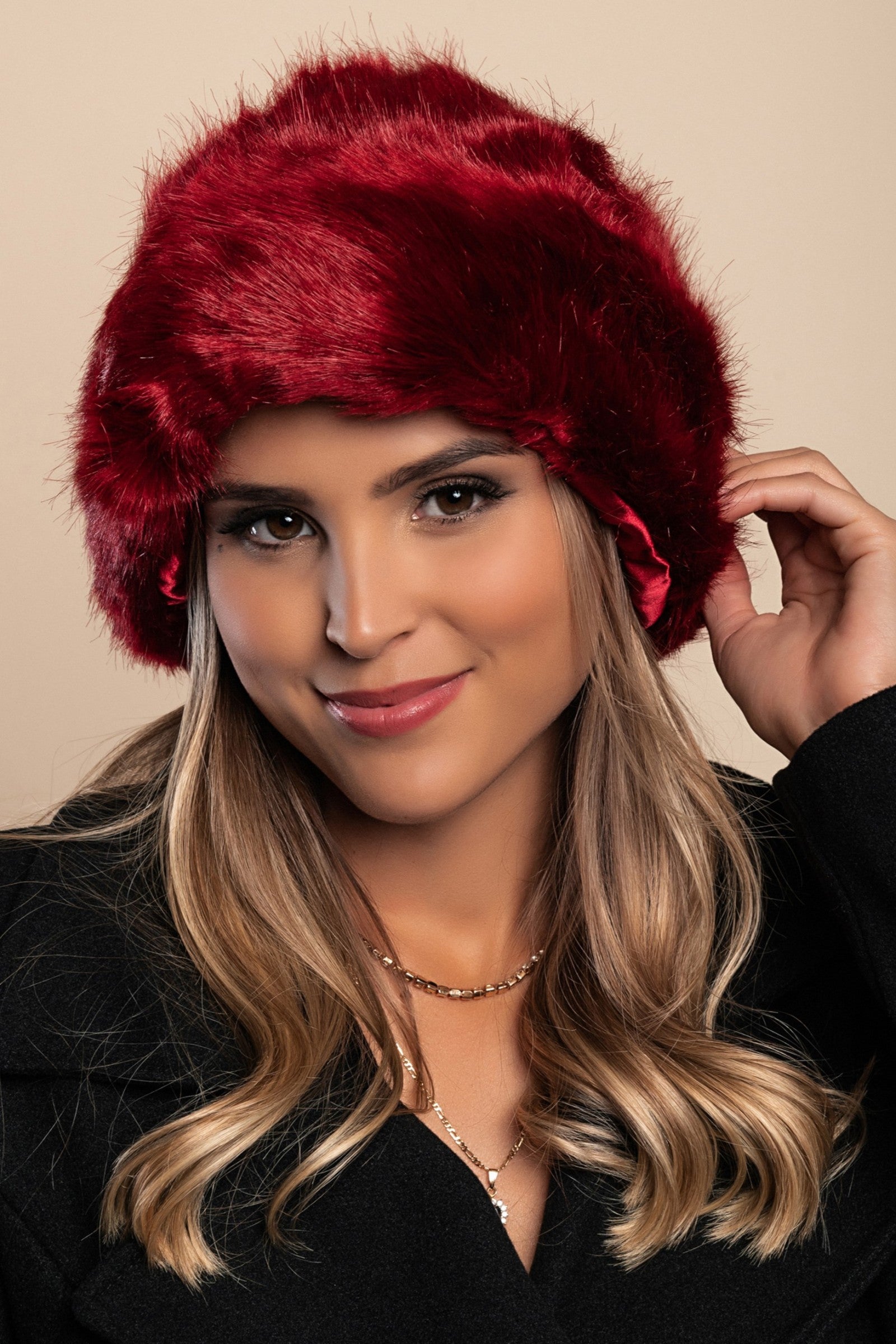 Elegant red winter hat with soft synthetic fur lining, perfect for cold weather.