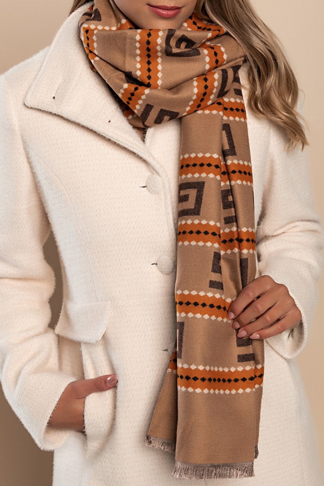 Elegant orange winter scarf with a stylish print, made from a soft blend of viscose, wool, and cashmere, perfect for cold weather.