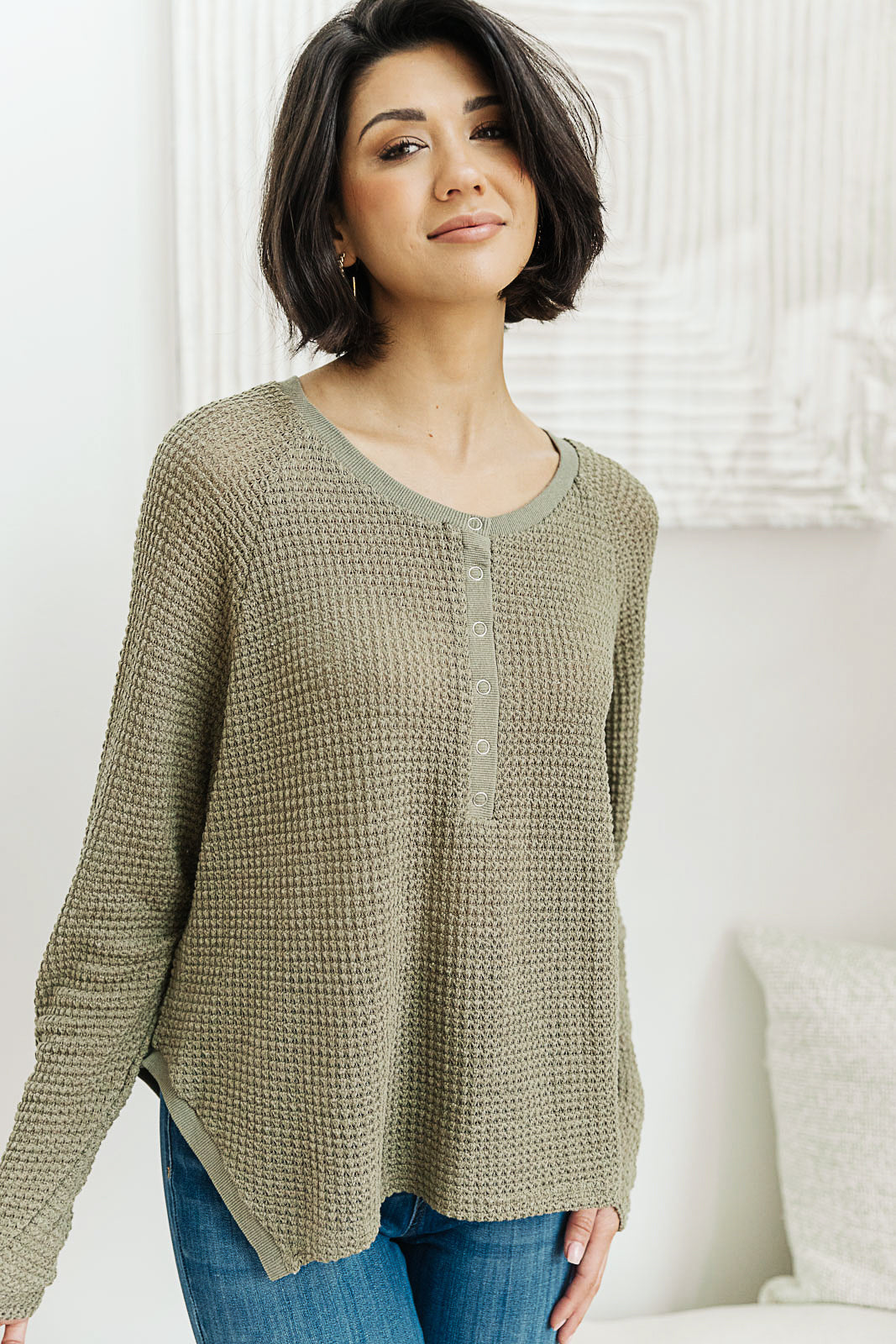 Wishful Thinking Henley in Olive, featuring a henley neckline and sharkbite hem, displayed on a model.