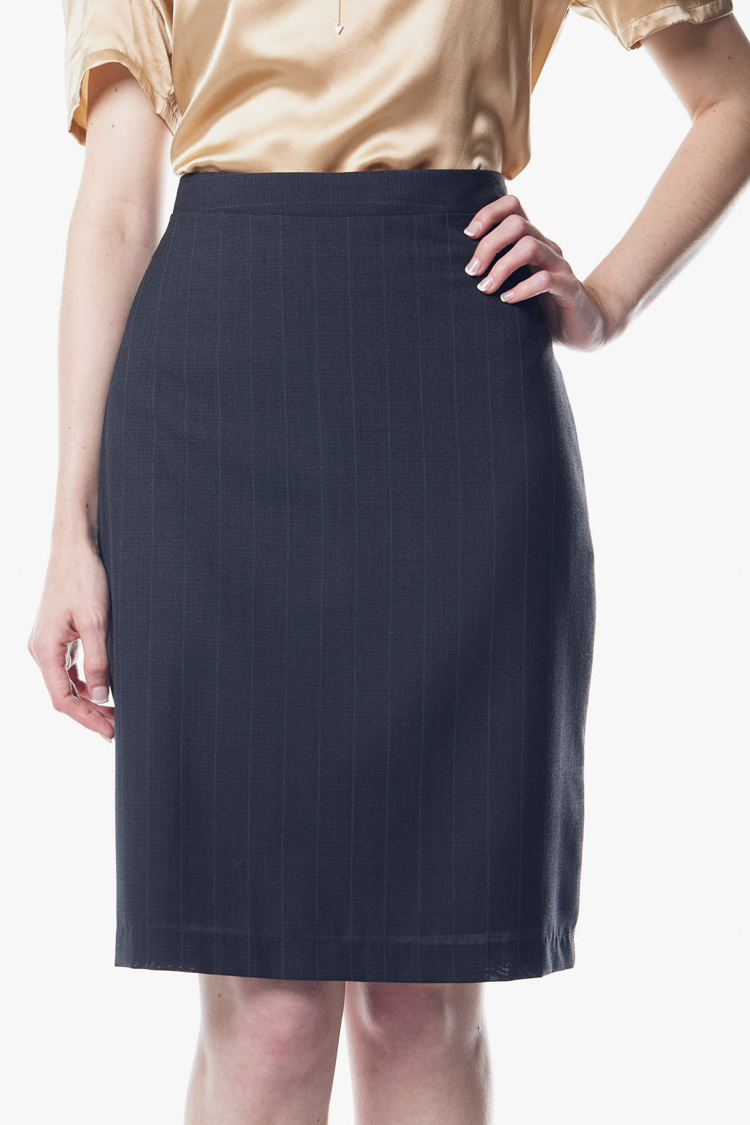 A luxurious gray wool pencil skirt displayed on a mannequin, showcasing its elegant design and soft fabric.