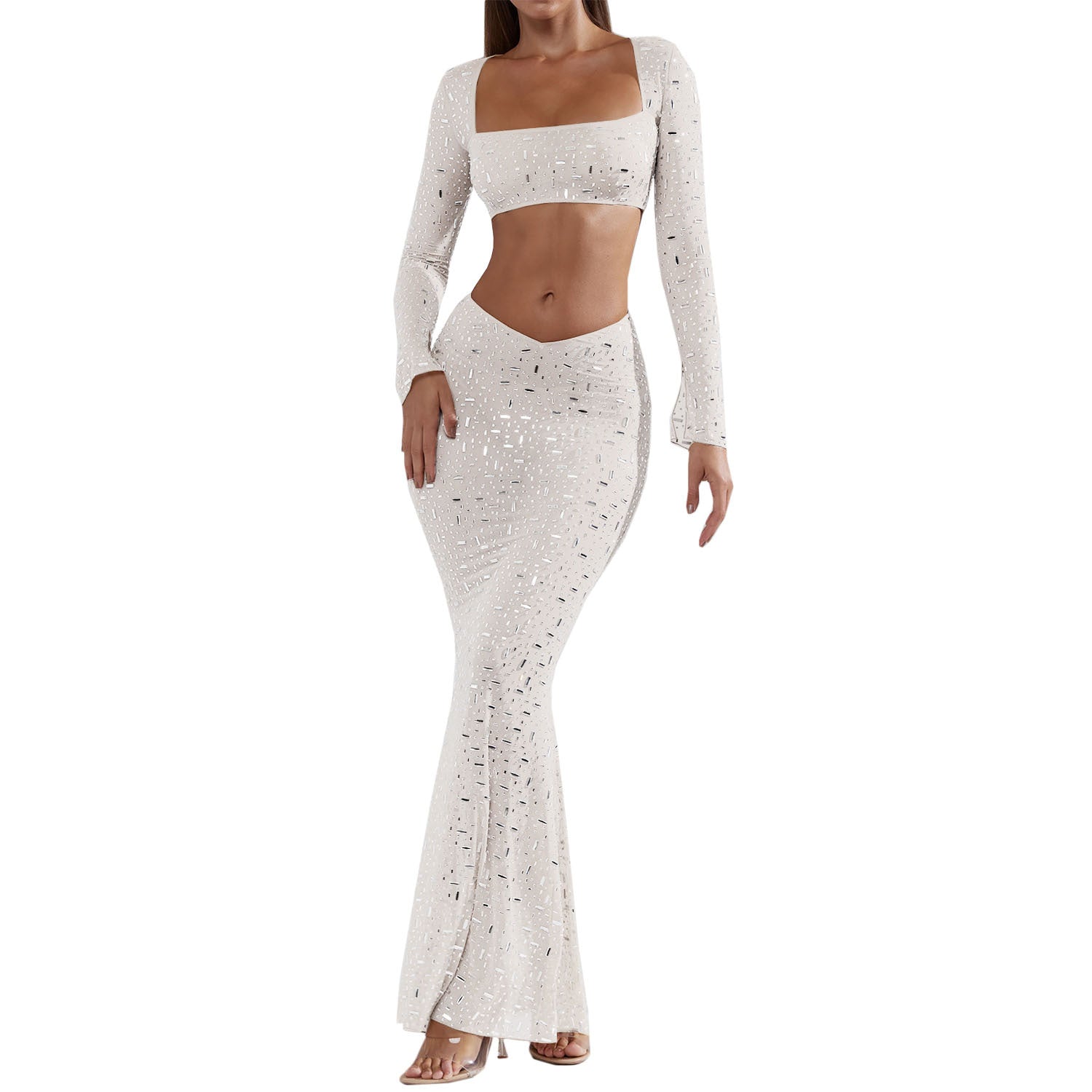 A stylish women's outfit featuring a sexy rhinestone crop top with long sleeves and a low-rise midi mermaid skirt, perfect for elegant occasions.