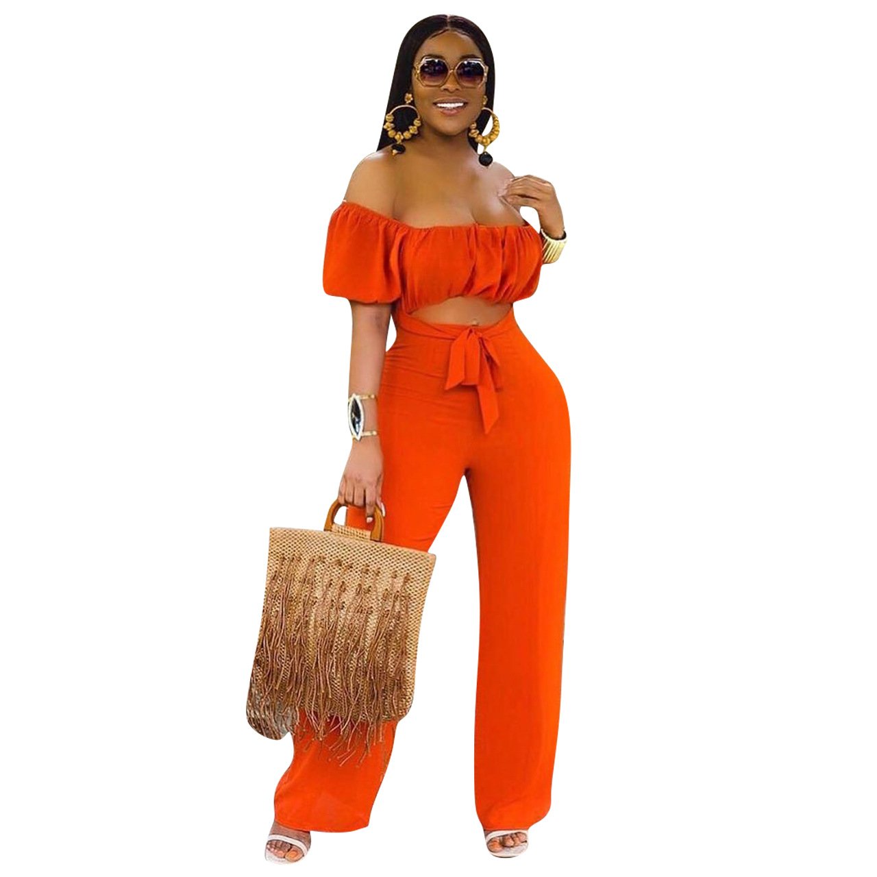 A stylish woman wearing a solid color backless off shoulder jumpsuit, showcasing its elegant design and comfortable fit.