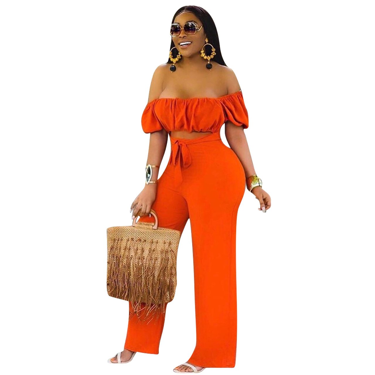 A stylish woman wearing a solid color backless off shoulder jumpsuit, showcasing its elegant design and comfortable fit.