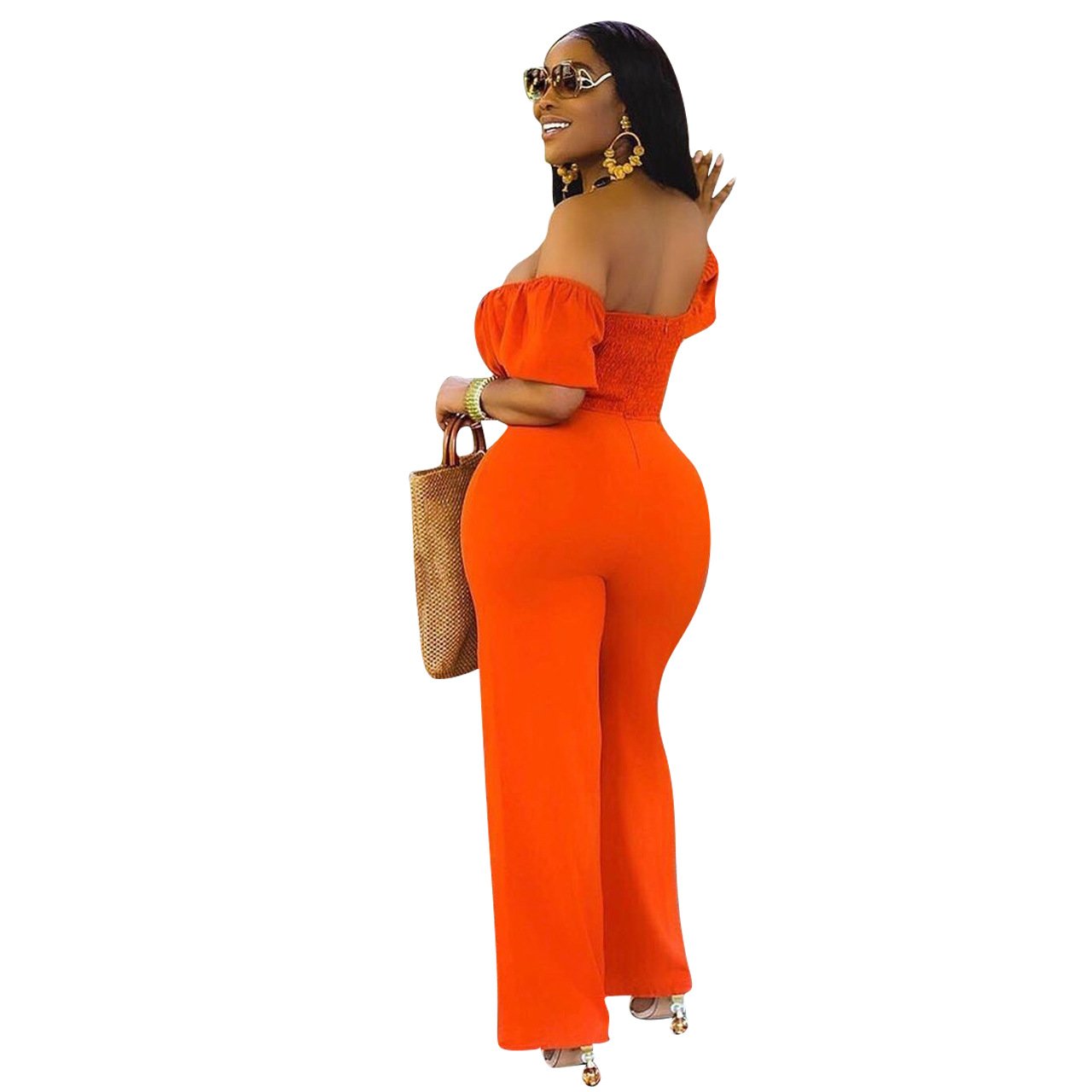 A stylish woman wearing a solid color backless off shoulder jumpsuit, showcasing its elegant design and comfortable fit.