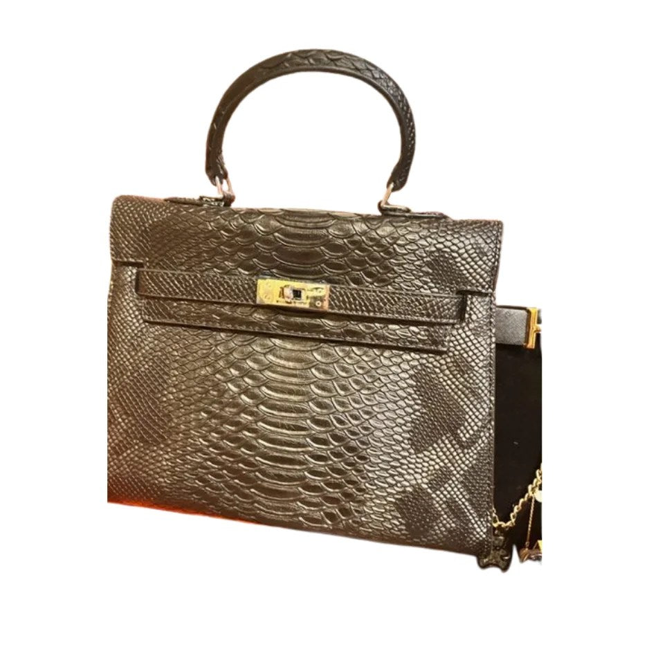 A stylish medium bag made from genuine alligator leather, featuring an open front pocket and elegant accessories like keys and a lock.