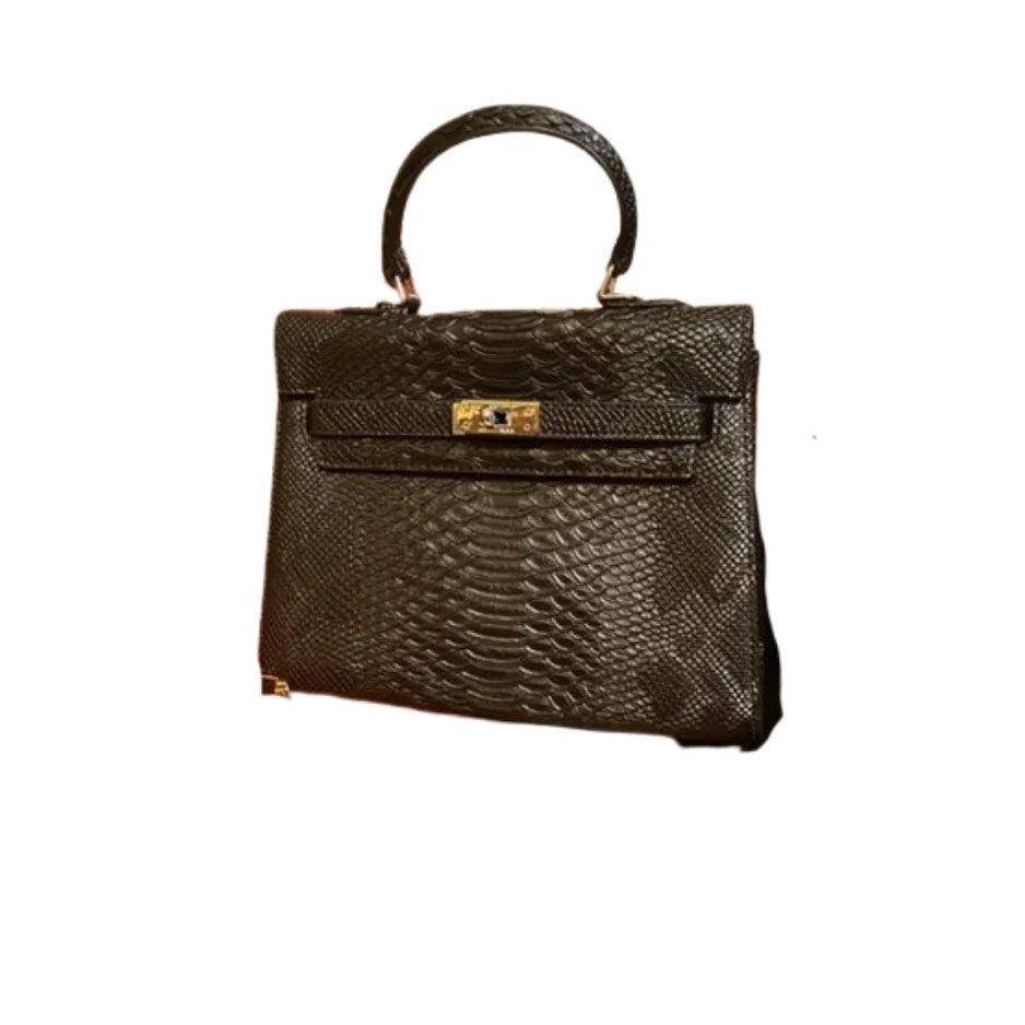 A stylish medium bag made from genuine alligator leather, featuring an open front pocket and elegant accessories like keys and a lock.