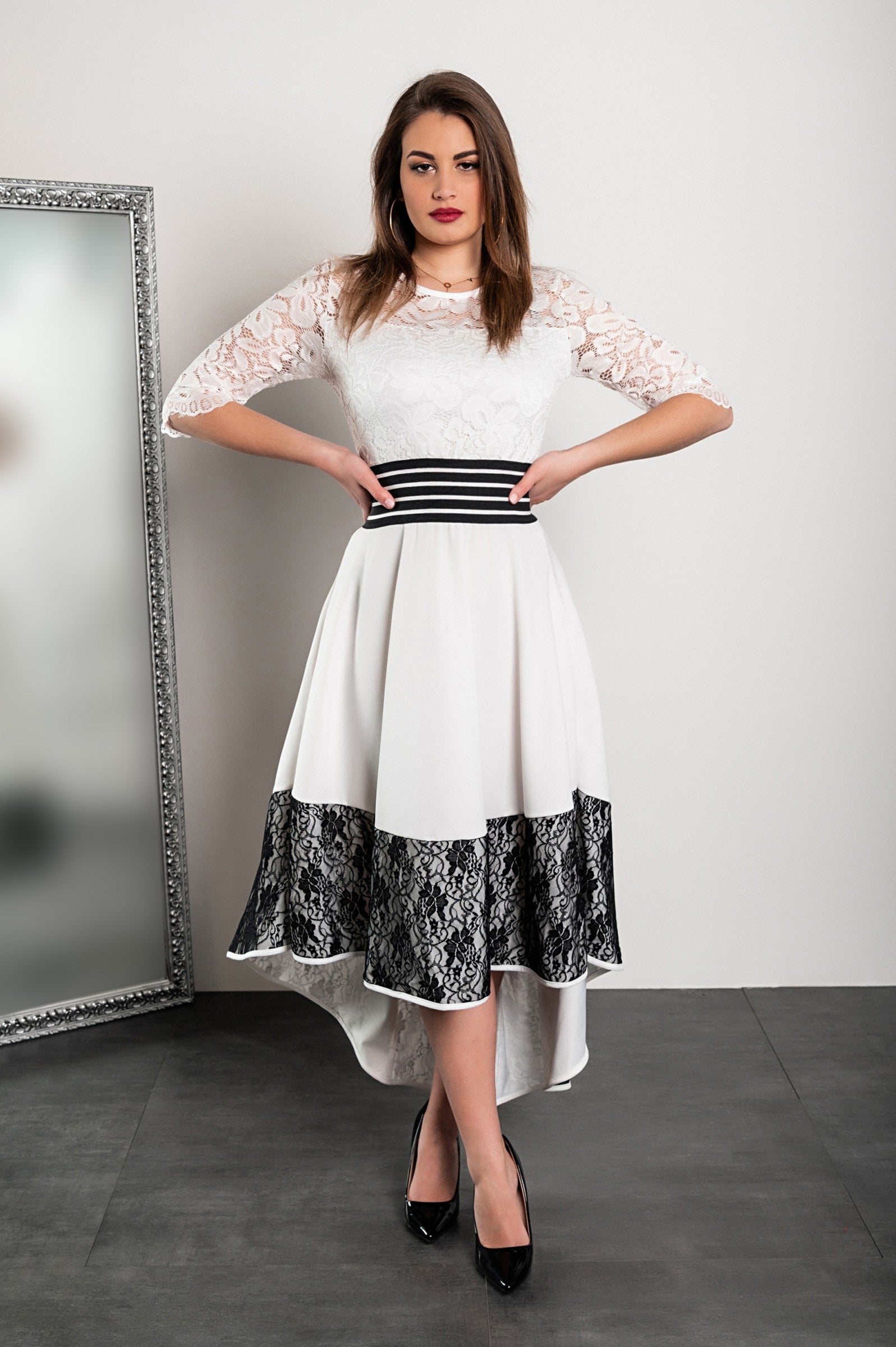 Elegant white asymmetrical dress with lace detailing, featuring 3/4 translucent sleeves and a tight waistband.