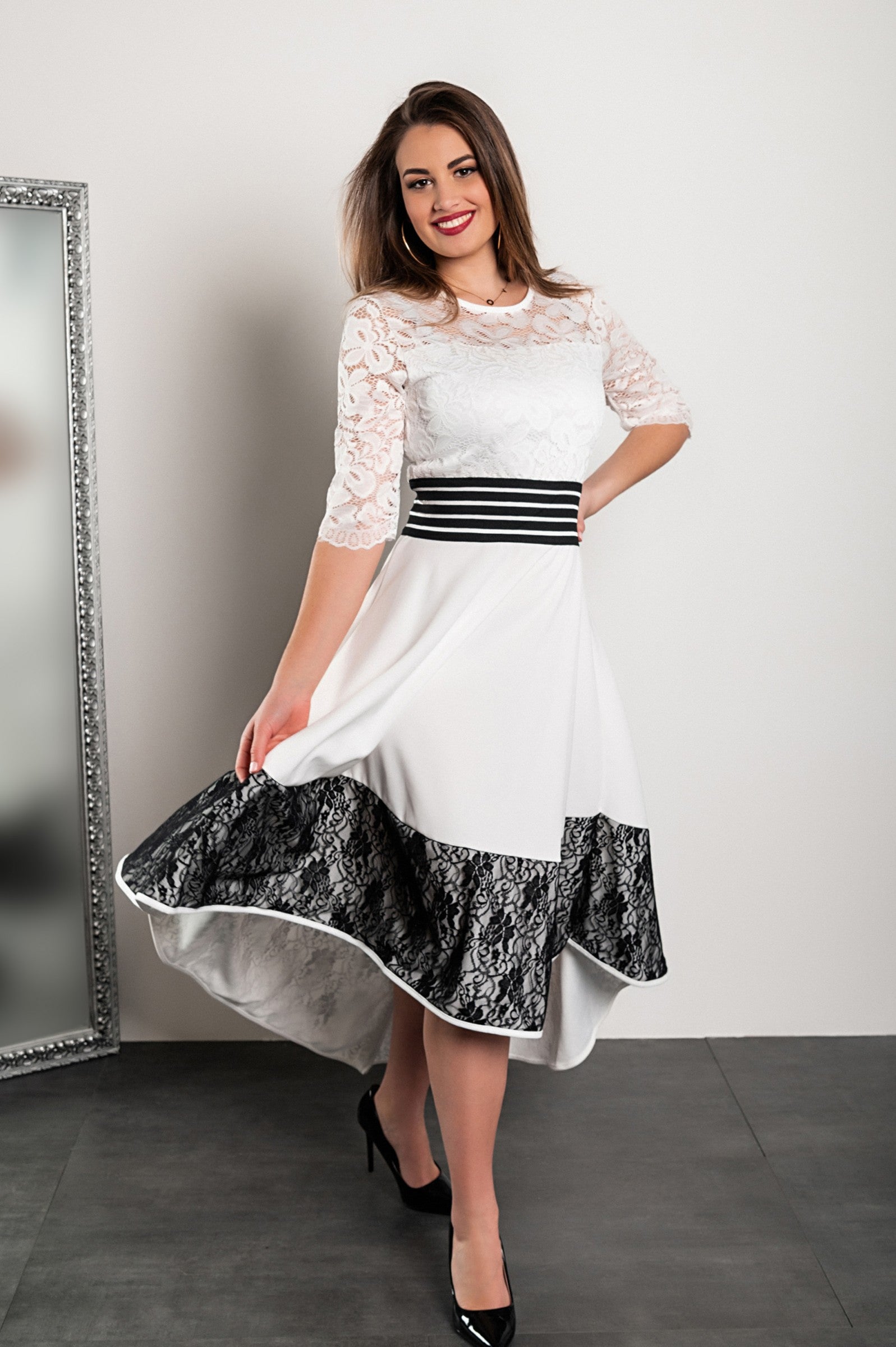 Elegant white asymmetrical dress with lace detailing, featuring 3/4 translucent sleeves and a tight waistband.